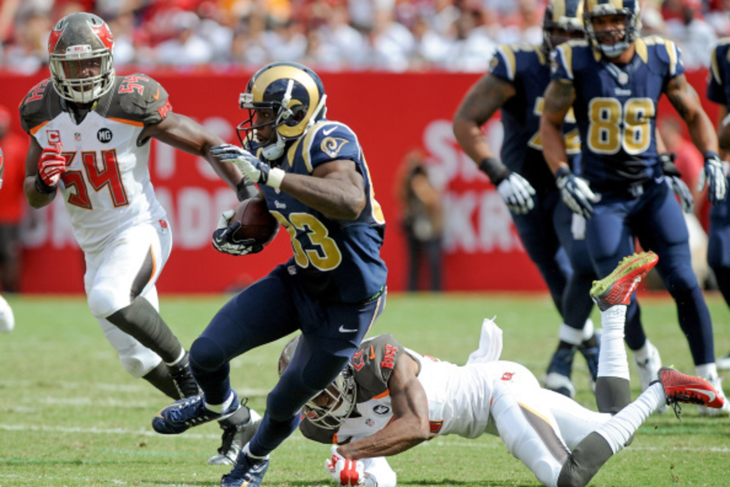 TAMPA, FL - SEPTEMBER 14: Brian Quick #83 of the St. Louis Rams avoids a tackle by Johnthan Banks #27 of the Tampa Bay Buccaneers during the first half of the game at Raymond James Stadium on September 14, 2014 in Tampa, Florida. (Photo by Cliff McBride/ TAMPA, FL - SEPTEMBER 14: Brian Quick #83 of the St. Louis Rams avoids a tackle by Johnthan Banks #27 of the Tampa Bay Buccaneers during the first half of the game at Raymond James Stadium on September 14, 2014 in Tampa, Florida. (Photo by Cliff McBride/