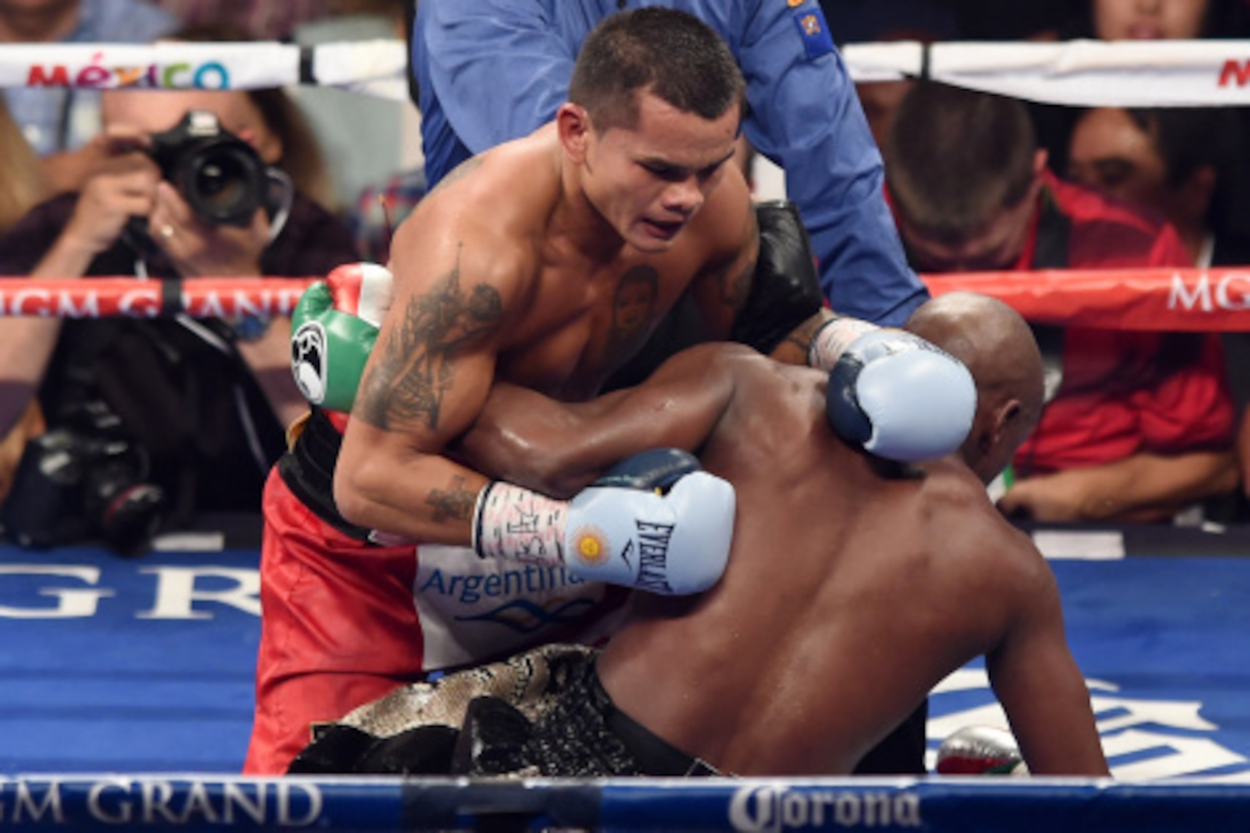 LAS VEGAS, NV - SEPTEMBER 13:  Referee Kenny Bayless grabs Marcos Maidana (C) as he pushes Floyd Mayweather Jr. down in the 10th round of their WBC/WBA welterweight title fight at the MGM Grand Garden Arena on September 13, 2014 in Las Vegas, Nevada. Bayl