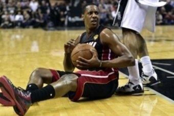 Jun 15, 2014; San Antonio, TX, USA; Miami Heat guard Mario Chalmers (15) reacts on the floor during the fourth quarter against the San Antonio Spurs in game five of the 2014 NBA Finals at AT&T Center. Mandatory Credit: Bob Donnan-USA TODAY Sports
