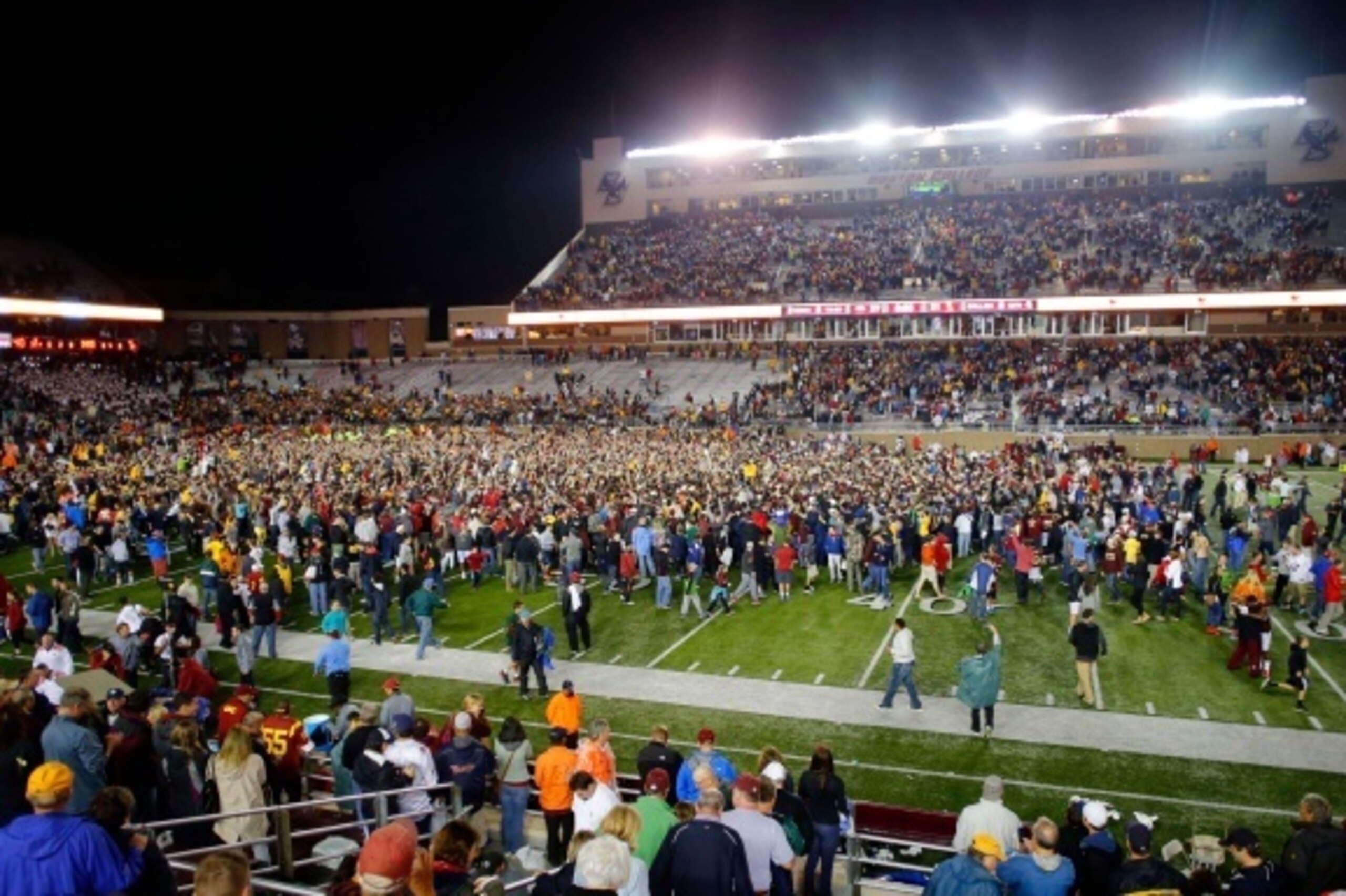 BOSTON, MA- SEPTEMBER 13:  Fans storm the field after the Boston College Eagles 37-31 win over the USC Trojans at Alumni Stadium on September 13 in Chestnut Hill, Massachusetts.  (Photo by Winslow Townson/Getty Images)
