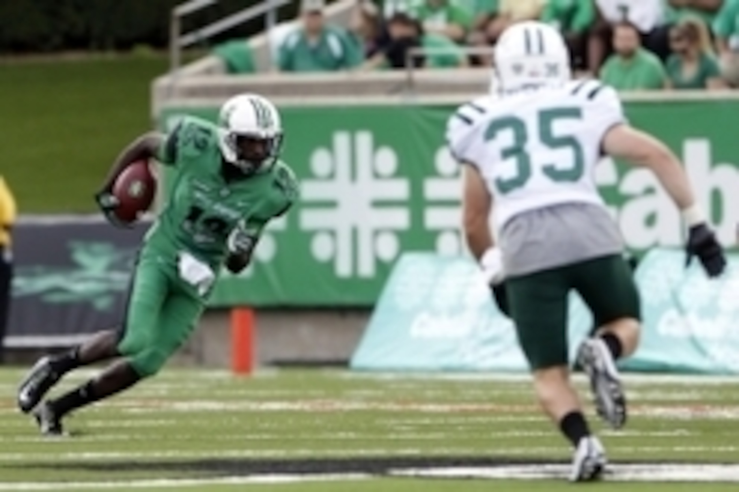 Sep 13, 2014; Huntington, WV, USA; Marshall Thundering Herd quarterback Rakeem Cato (12) runs the ball against Ohio Bobcats safety Nathan Carpenter (35) in the second half at Joan C. Edwards Stadium. Marshall defeated Ohio 44-14. Mandatory Credit: Mark Ze