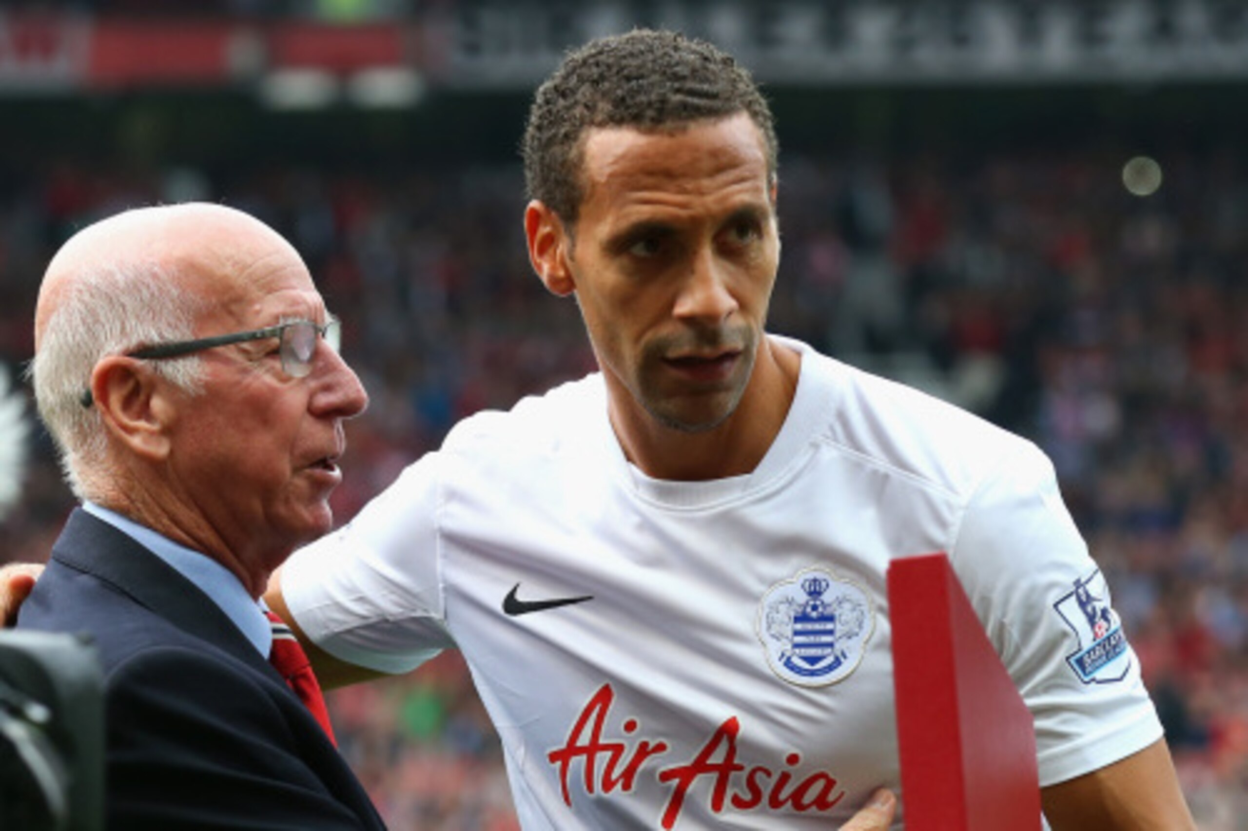 MANCHESTER, ENGLAND - SEPTEMBER 14: Sir Bobby Charlton makes a presentation to Rio Ferdinand of QPR prior to the Barclays Premier League match between Manchester United and Queens Park Rangers at Old Trafford on September 14, 2014 in Manchester, England. MANCHESTER, ENGLAND - SEPTEMBER 14: Sir Bobby Charlton makes a presentation to Rio Ferdinand of QPR prior to the Barclays Premier League match between Manchester United and Queens Park Rangers at Old Trafford on September 14, 2014 in Manchester, England.