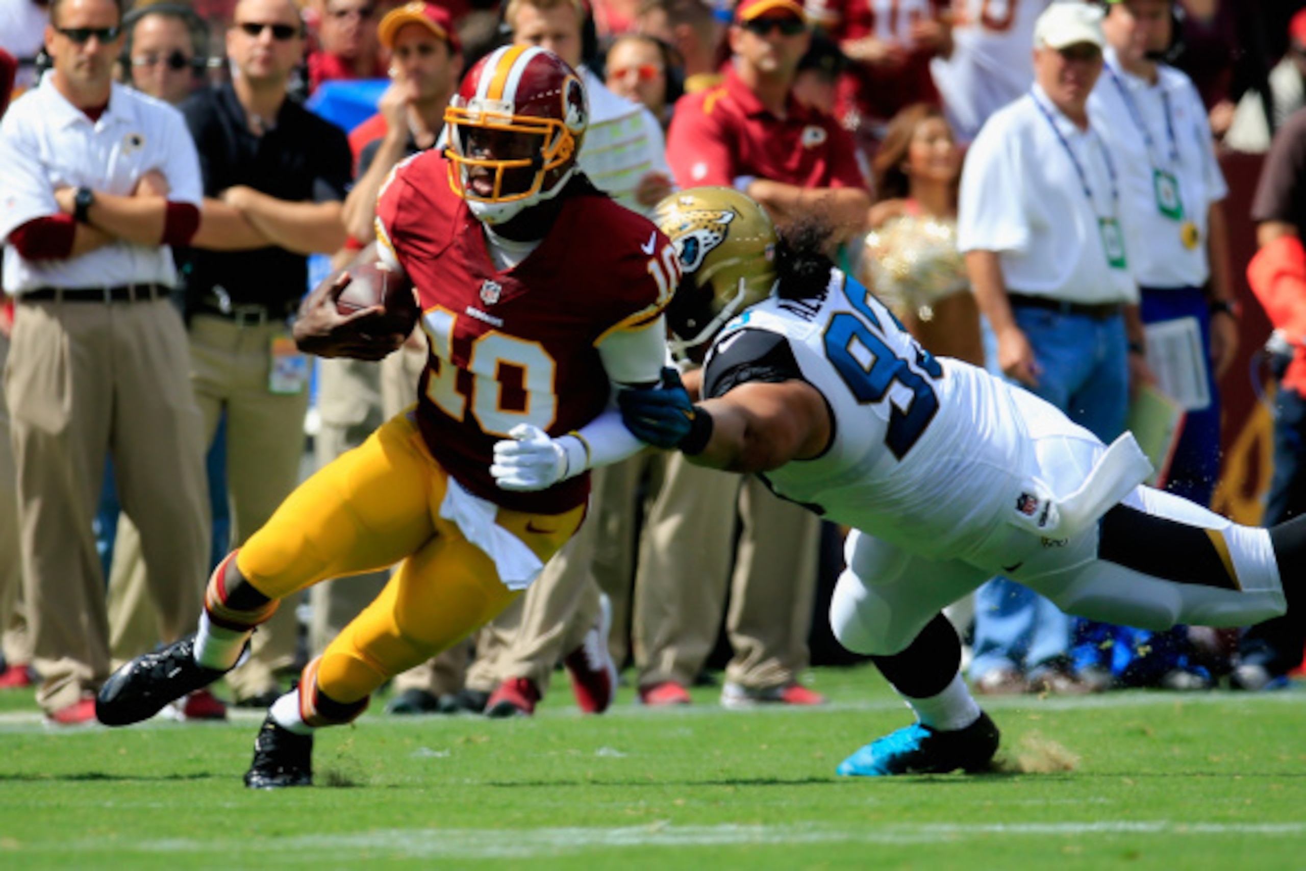 LANDOVER, MD - SEPTEMBER 14:  Quarterback Robert Griffin III #10 of the Washington Redskins rushes during the first quarter of a game against the Jacksonville Jaguars at FedExField on September 14, 2014 in Landover, Maryland.  (Photo by Rob Carr/Getty Ima