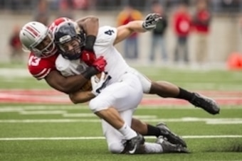 Sep 13, 2014; Columbus, OH, USA; Ohio State Buckeyes linebacker Darron Lee (43) tackles Kent State Golden Flashes running back Nick Holley (4) at Ohio Stadium. Ohio State won the game 66-0. Mandatory Credit: Greg Bartram-USA TODAY Sports