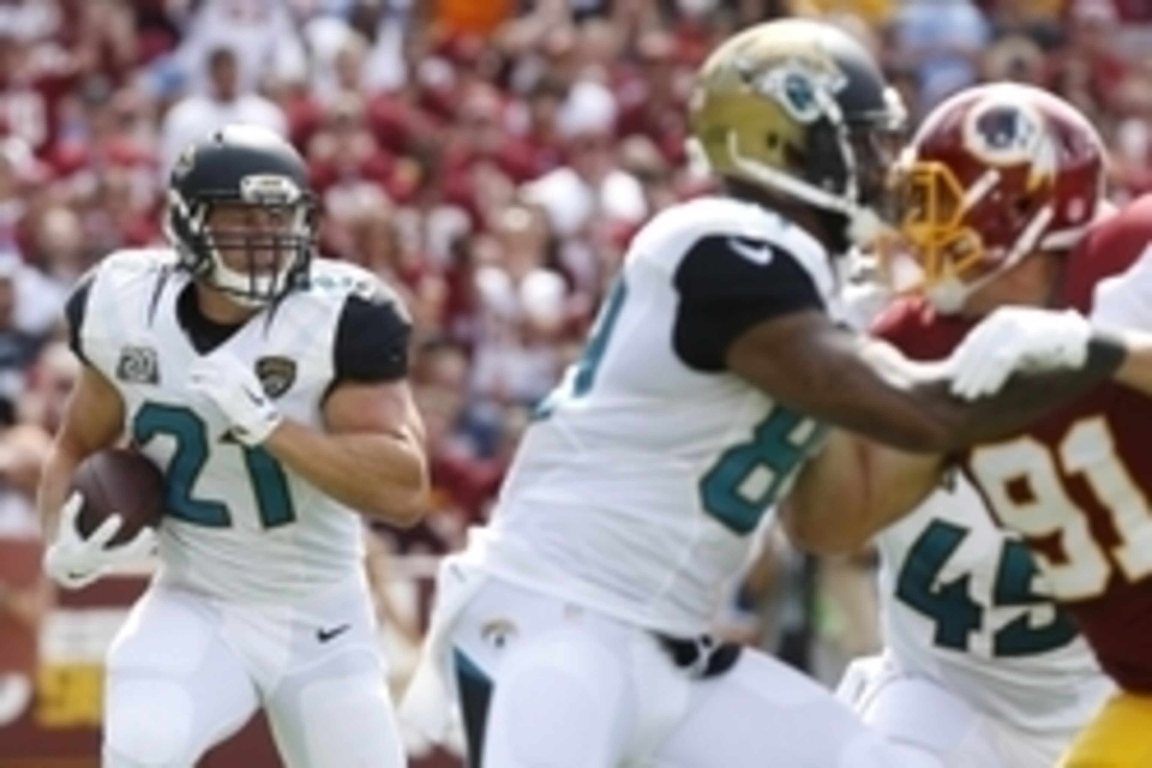 Sep 14, 2014; Landover, MD, USA; Jacksonville Jaguars running back Toby Gerhart (21) carries the ball against the Washington Redskins in the first half at FedEx Field. Mandatory Credit: Geoff Burke-USA TODAY Sports