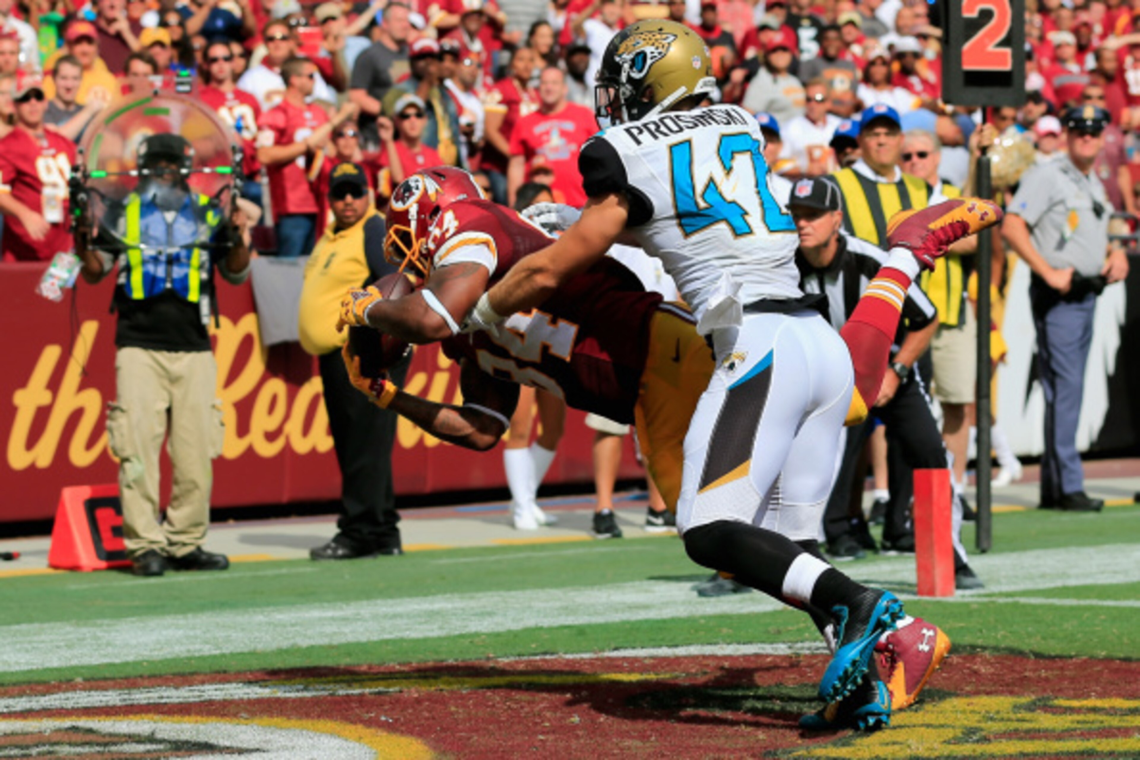 LANDOVER, MD - SEPTEMBER 14: Tight end Niles Paul #84 of the Washington Redskins catches a fourth quarter touchdown over strong safety Chris Prosinski #42 of the Jacksonville Jaguars during the second half at FedExField on September 14, 2014 in Landover, 