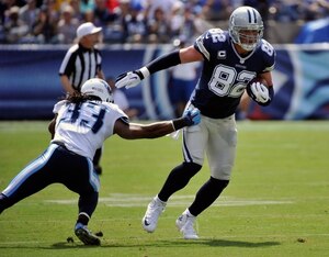 NASHVILLE, TN - SEPTEMBER 14:  Jason Witten #82 of the Dallas Cowboys runs through the tackle of Michael Griffin #33 of the Tennessee Titans during the first half of a game at LP Field on September 14, 2014 in Nashville, Tennessee.  (Photo by Frederick Br
