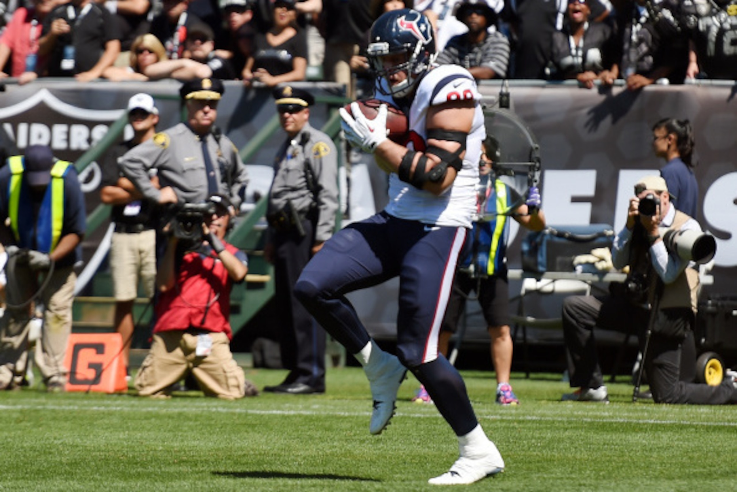 OAKLAND, CA - SEPTEMBER 14:  J.J. Watt #99 of the Houston Texans catches a one yard touchdown pass against the Oakland Raiders during the first quarter at O.co Coliseum on September 14, 2014 in Oakland, California.  (Photo by Thearon W. Henderson/Getty Im