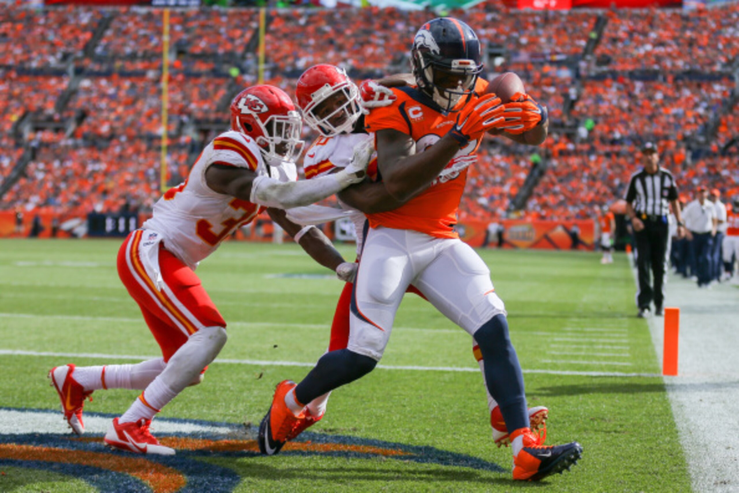 DENVER, CO - SEPTEMBER 14: Wide receiver Demaryius Thomas #88 of the Denver Broncos has a second quarter 12 yard touchdown catch under coverage by free safety Husain Abdullah #39 of the Kansas City Chiefs and cornerback Chris Owens #20 at Sports Authority
