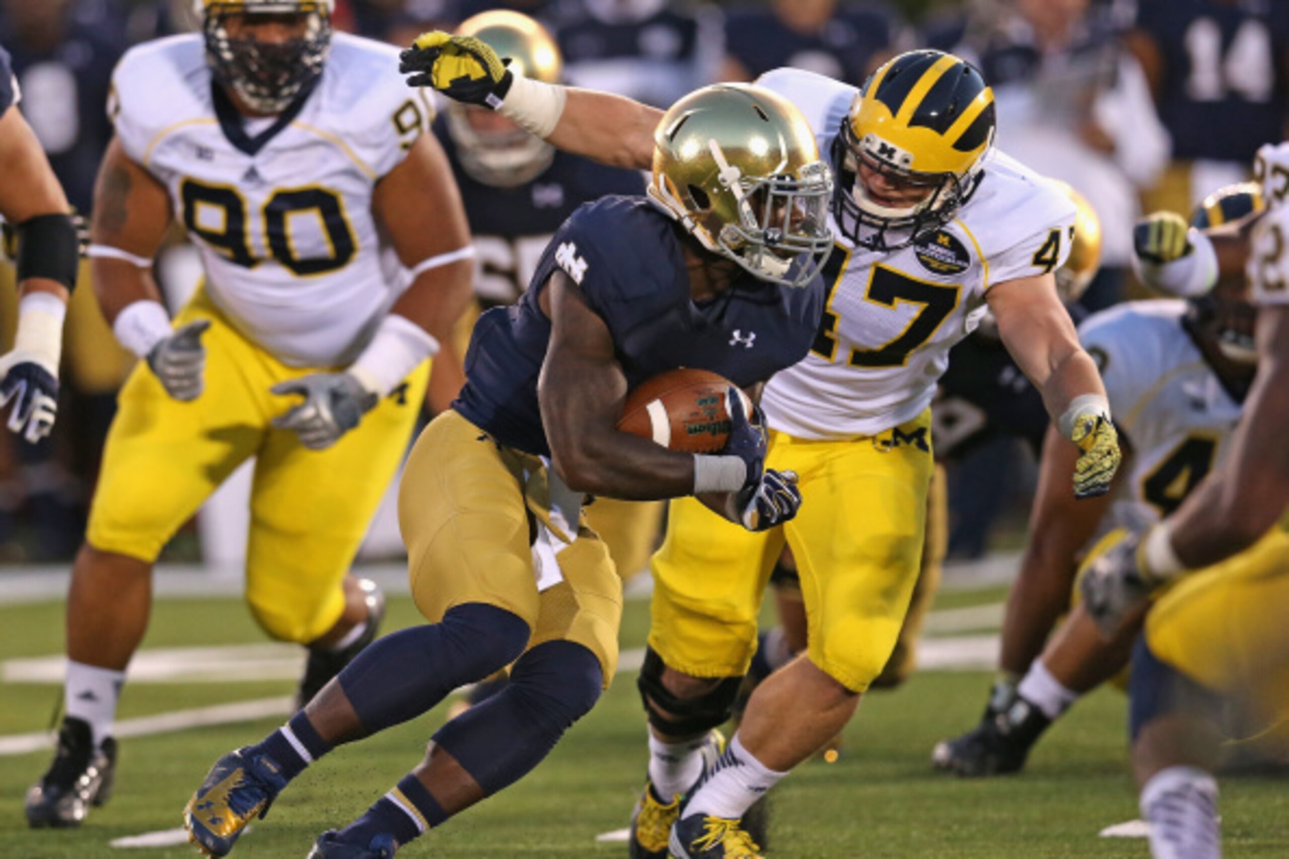 SOUTH BEND, IN - SEPTEMBER 06: Greg Bryant #1 of the Notre Dame Fighting Irish runs as Jake Ryan #47 of the Michigan Wolverines closes in at Notre Dame Stadium on September 6, 2014 in South Bend, Indiana. (Photo by Jonathan Daniel/Getty Images)