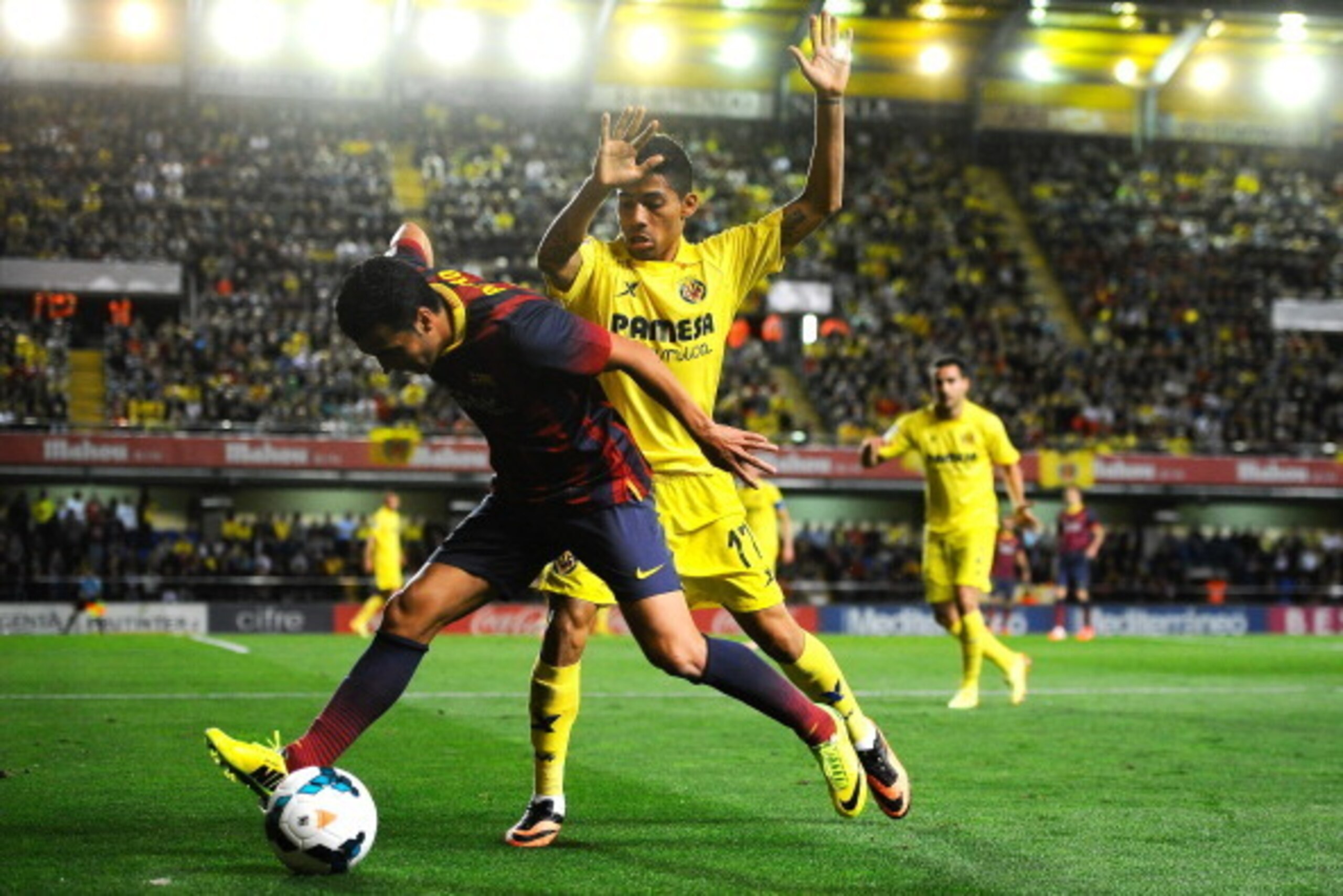VILLARREAL, SPAIN - APRIL 27:  Pedro Rodriguez of FC Barcelona duels for the ball with Javier Aquino of Villarreal CF during the La Liga match between Villarreal CF and FC Barcelona at El Madrigal on April 27, 2014 in Villarreal, Spain.  (Photo by David R