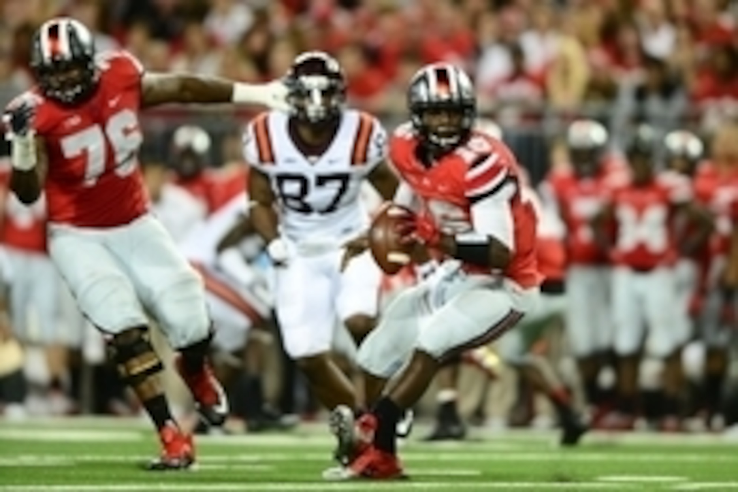 Sep 6, 2014; Columbus, OH, USA; Ohio State Buckeyes quarterback J.T. Barrett (16) pitches the ball during the third quarter against the Virginia Tech Hokies at Ohio Stadium. Mandatory Credit: Andrew Weber-USA TODAY Sports