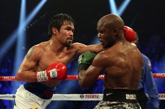 LAS VEGAS, NV - APRIL 12:  Manny Pacquiao throws a left hand at Timothy Bradley at the MGM Grand Garden Arena on April 12, 2014 in Las Vegas, Nevada.  (Photo by Jeff Gross/Getty Images)
