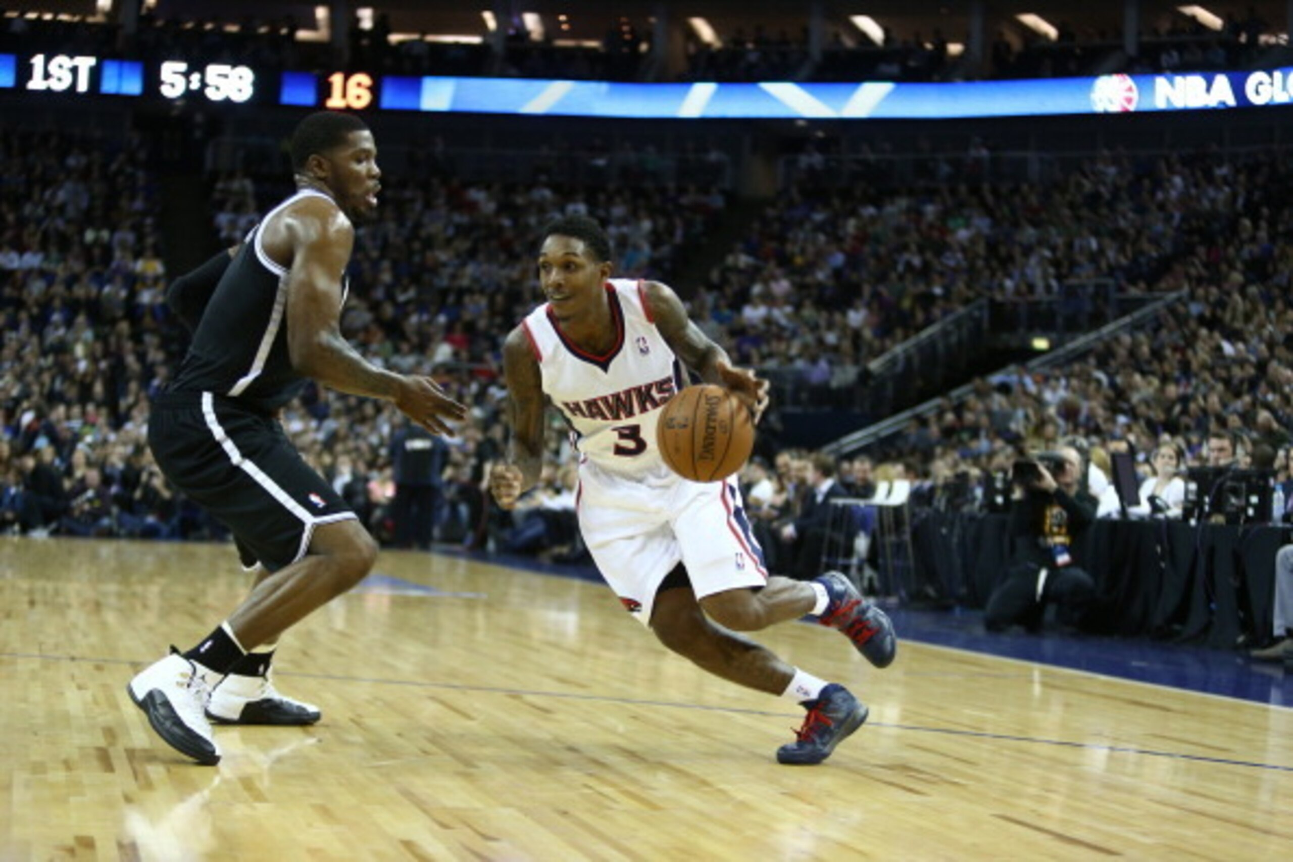 LONDON, ENGLAND - JANUARY 16: Lou Williams #3 of the Atlanta Hawks drives against Joe Johnson #7 of the Brooklyn Nets as part of  the 2014 Global Games on January 16, 2014 at The O2 Arena in London, England. NOTE TO USER: User expressly acknowledges and a