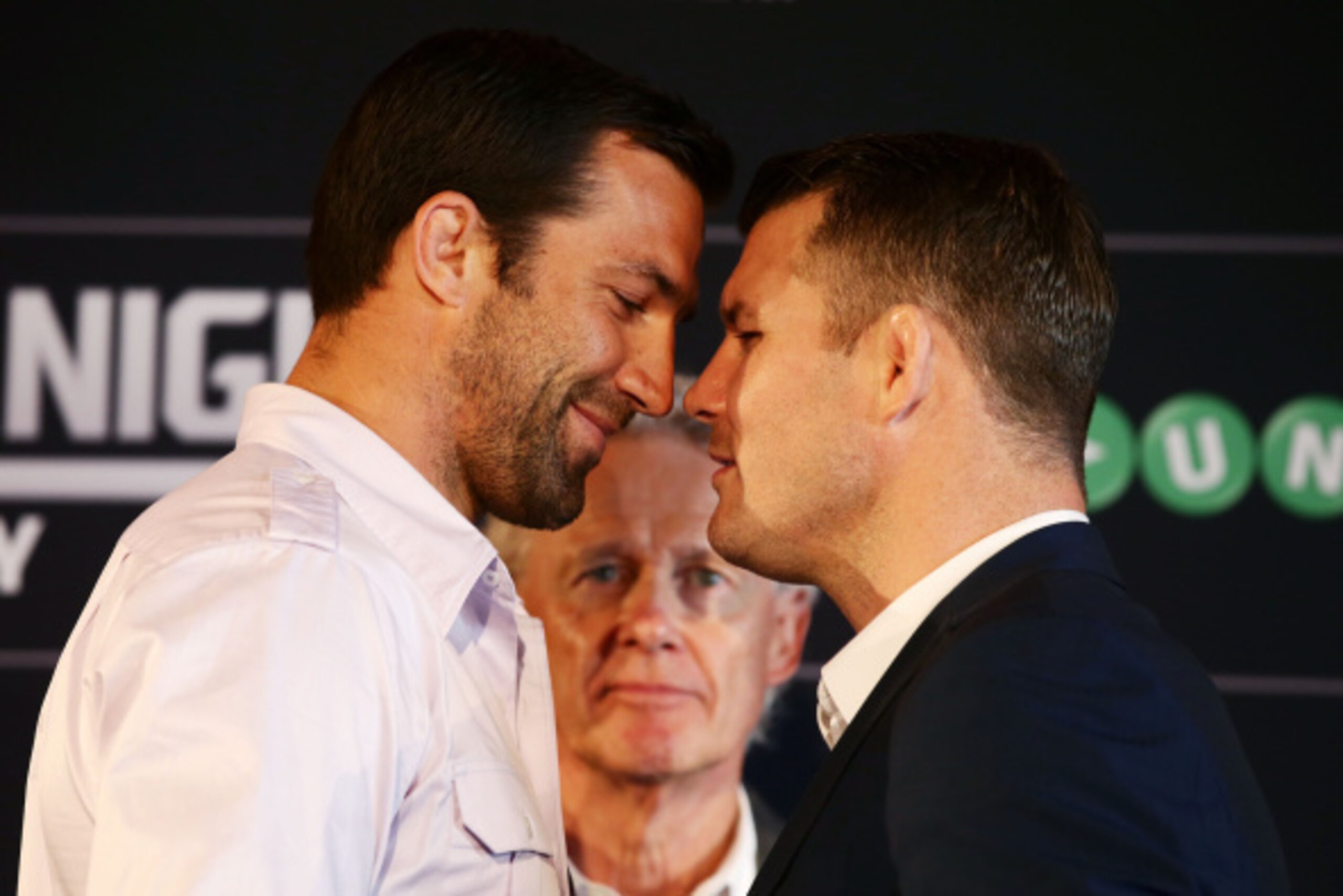 SYDNEY, AUSTRALIA - SEPTEMBER 11:  Luke Rockhold (L) and Michael Bisping (R) sqaure off as UFC Managing Director Australia, Canada and New Zealand Tom Wright (C) looks on during the UFC Fight Night: Rockhold v Bisping Press Event at Museum of Contemporary