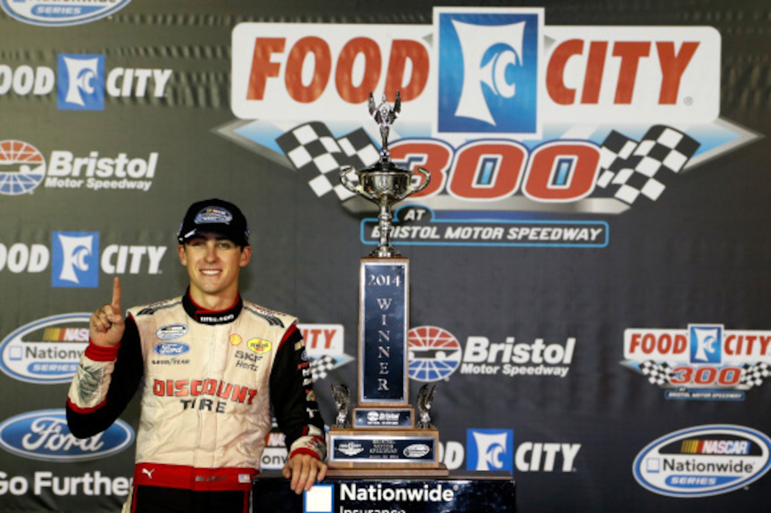 BRISTOL, TN - AUGUST 22:  Ryan Blaney, driver of the #22 Discount Tire Ford, celebrates with the trophy in Victory Lane after winning the NASCAR Nationwide Series Food City 300 at Bristol Motor Speedway on August 22, 2014 in Bristol, Tennessee.  (Photo by