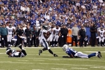 Sep 15, 2014; Indianapolis, IN, USA; Indianapolis Colts wide receiver T.Y. Hilton (13) lays on the ground as Philadelphia Eagles safety Malcolm Jenkins (27) intercepts the ball at Lucas Oil Stadium.  The result was a controversial play in the game. Philad