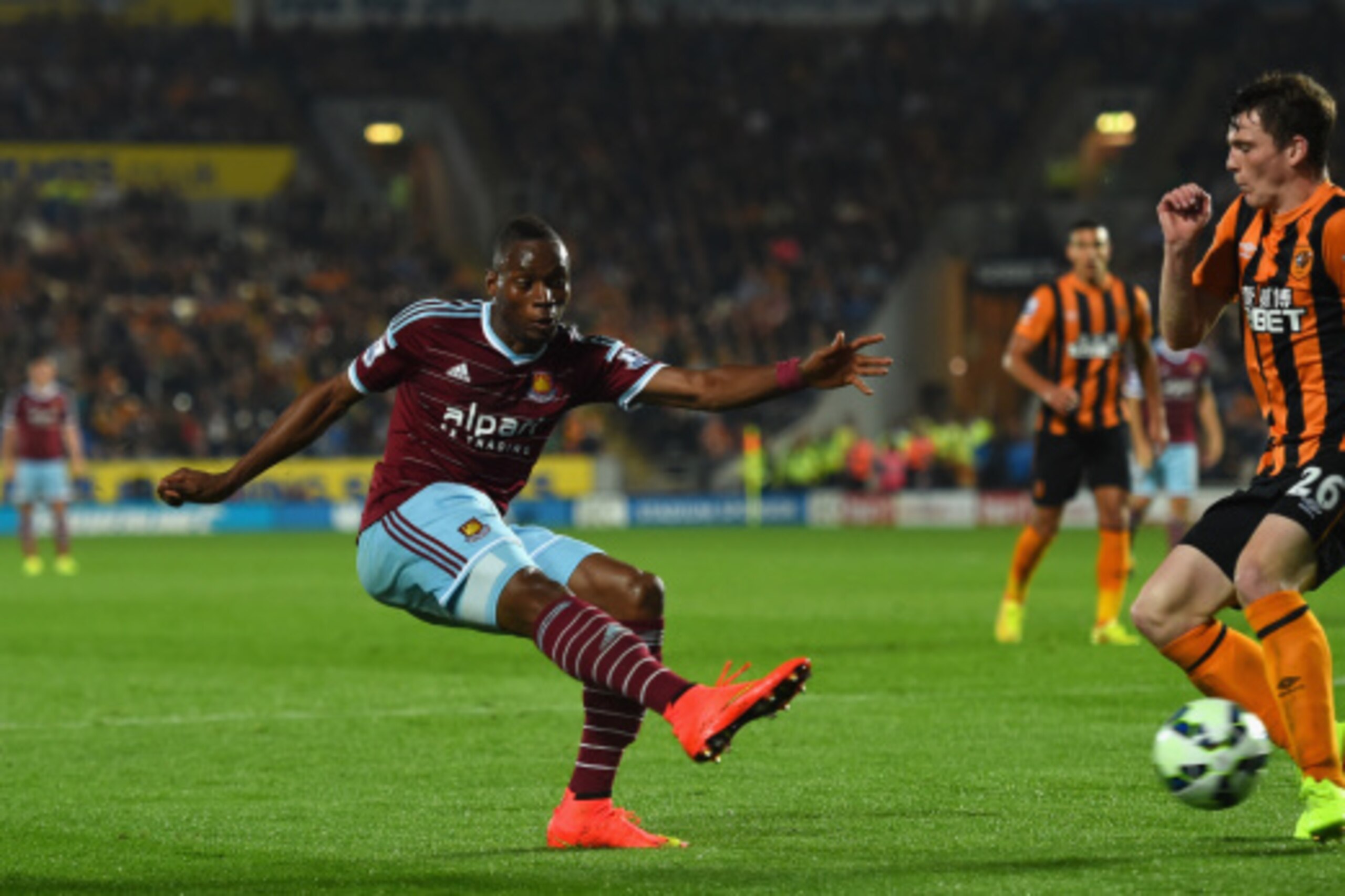 HULL, ENGLAND - SEPTEMBER 15:  West Ham player Diafra Sakho (l) shoots past Andy Robertson of Hull for the second West Ham goal during the Barclays Premier League match between Hull City and West Ham United at KC Stadium on September 15, 2014 in Hull, Eng