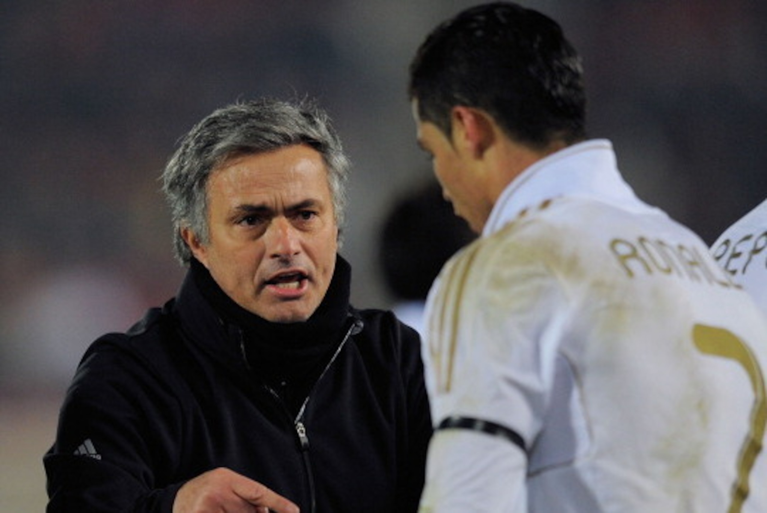 PALMA DE MALLORCA, SPAIN - JANUARY 14: Real Madrid head coach Jose Mourinho has a word with Cristiano Ronaldo during the La Liga match between RCD Mallorca and Real Madrid at Iberostar Stadium on January 14, 2012 in Palma de Mallorca, Spain.  (Photo by De