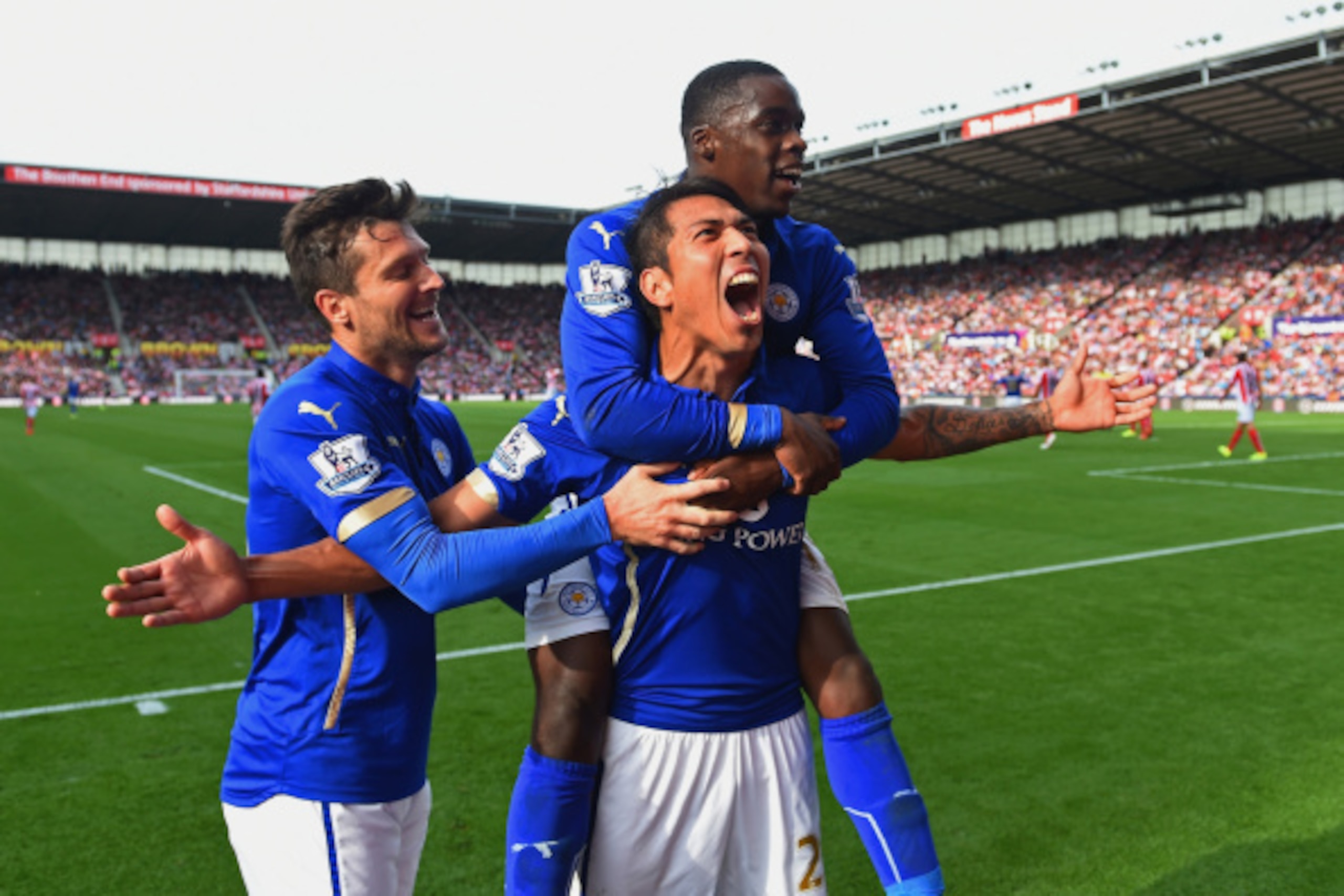 STOKE ON TRENT, ENGLAND - SEPTEMBER 13:  Leonardo Ulloa of Leicester City celebrates scoring the first goal with David Nugent and Jeffrey Schlupp of Leicester City during the Barclays Premier League match between Stoke City and Leicester City  at Britanni