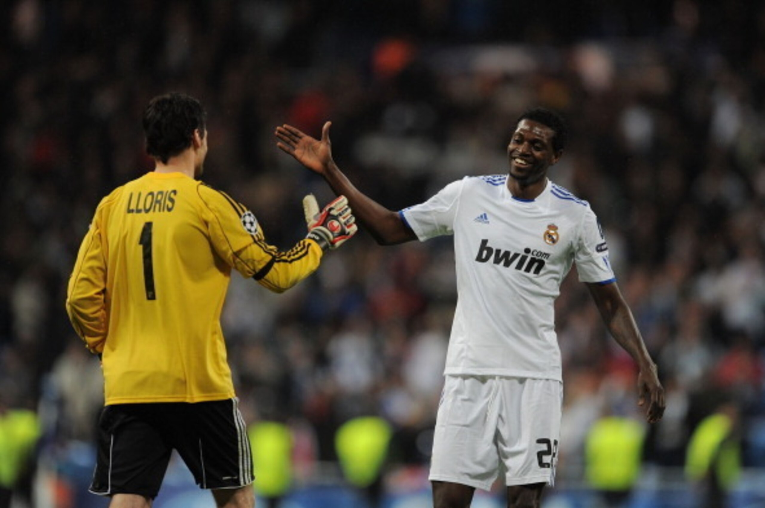 MADRID, SPAIN - MARCH 16: Emmanuel Adebayor (R) of Real Madrid shakes hands with Hugo Lloris of Lyon after Real beat Lyon 3-0 in the UEFA Champions League round of 16 second leg match between at Estadio Santiago Bernabeu on March 16, 2011 in Madrid, Spai MADRID, SPAIN - MARCH 16: Emmanuel Adebayor (R) of Real Madrid shakes hands with Hugo Lloris of Lyon after Real beat Lyon 3-0 in the UEFA Champions League round of 16 second leg match between at Estadio Santiago Bernabeu on March 16, 2011 in Madrid, Spai