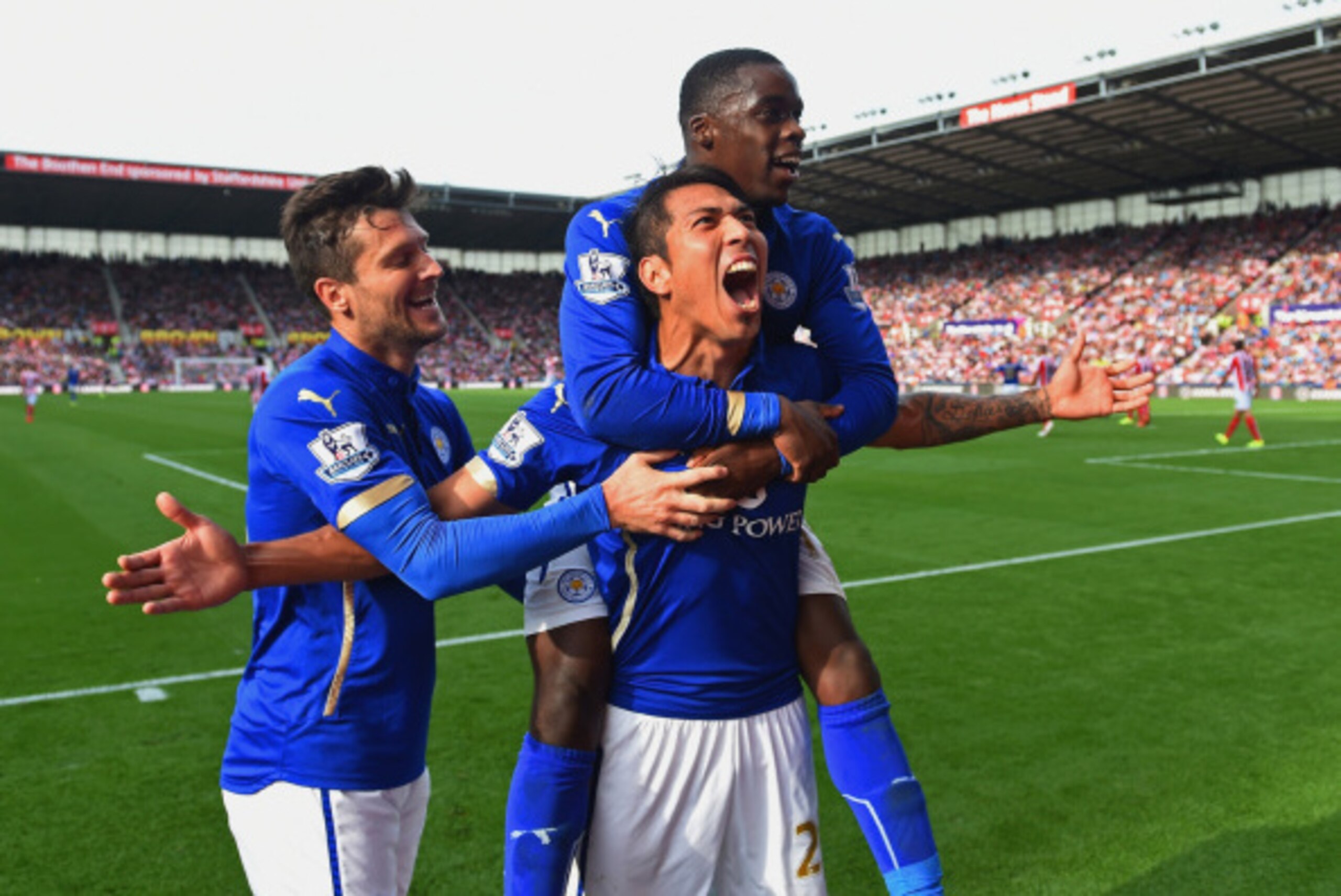 STOKE ON TRENT, ENGLAND - SEPTEMBER 13:  Leonardo Ulloa of Leicester City celebrates scoring the first goal with David Nugent and Jeffrey Schlupp of Leicester City during the Barclays Premier League match between Stoke City and Leicester City  at Britanni