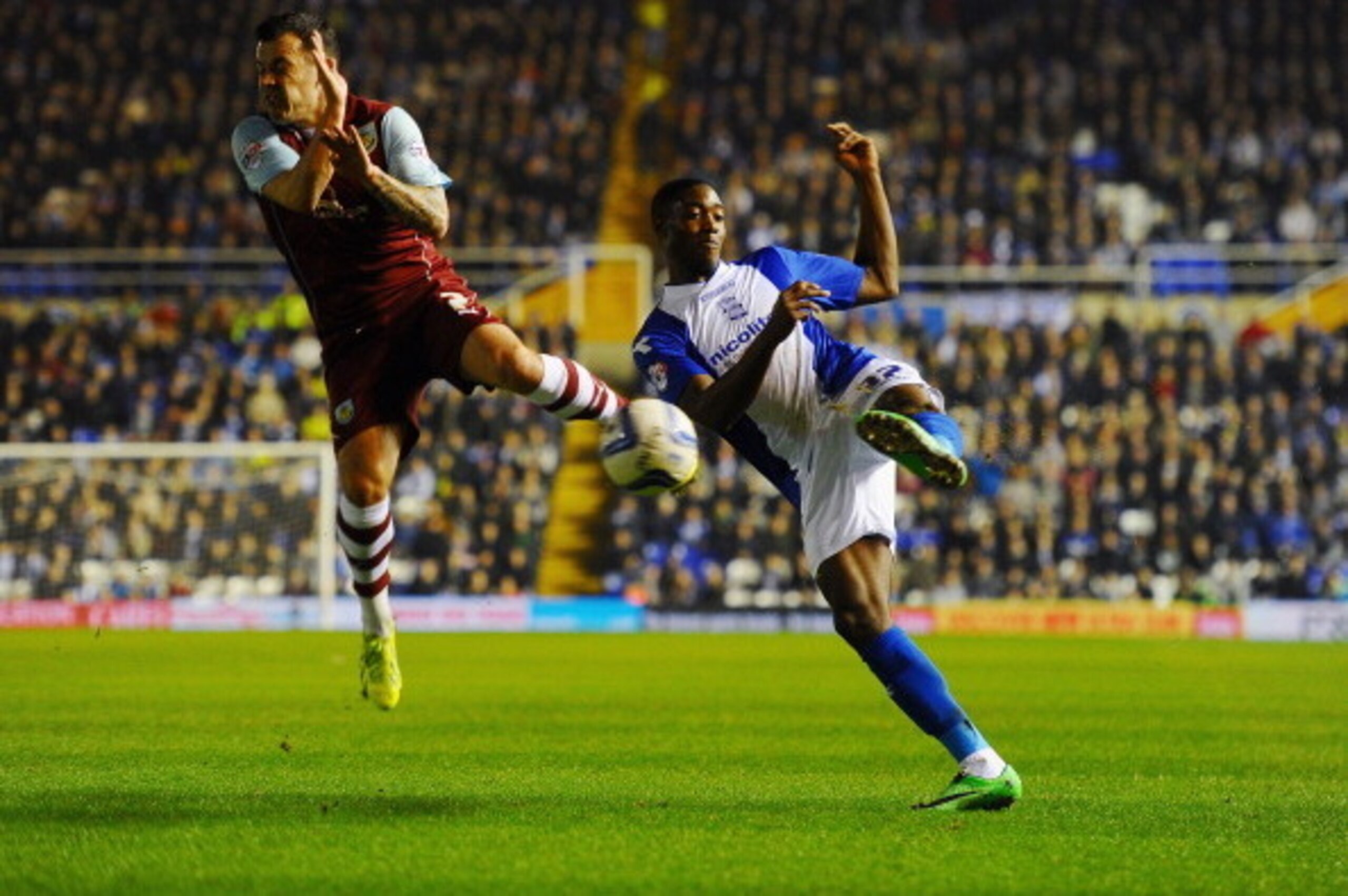 BIRMINGHAM, ENGLAND - MARCH 12: Tyler Blackett of Birmingham City battles with Ross Wallace of Burnley during the Sky Bet Championship match between Birmingham City and Burnley at St Andrews (stadium) on March 12, 2014 in Birmingham, England.  (Photo by L