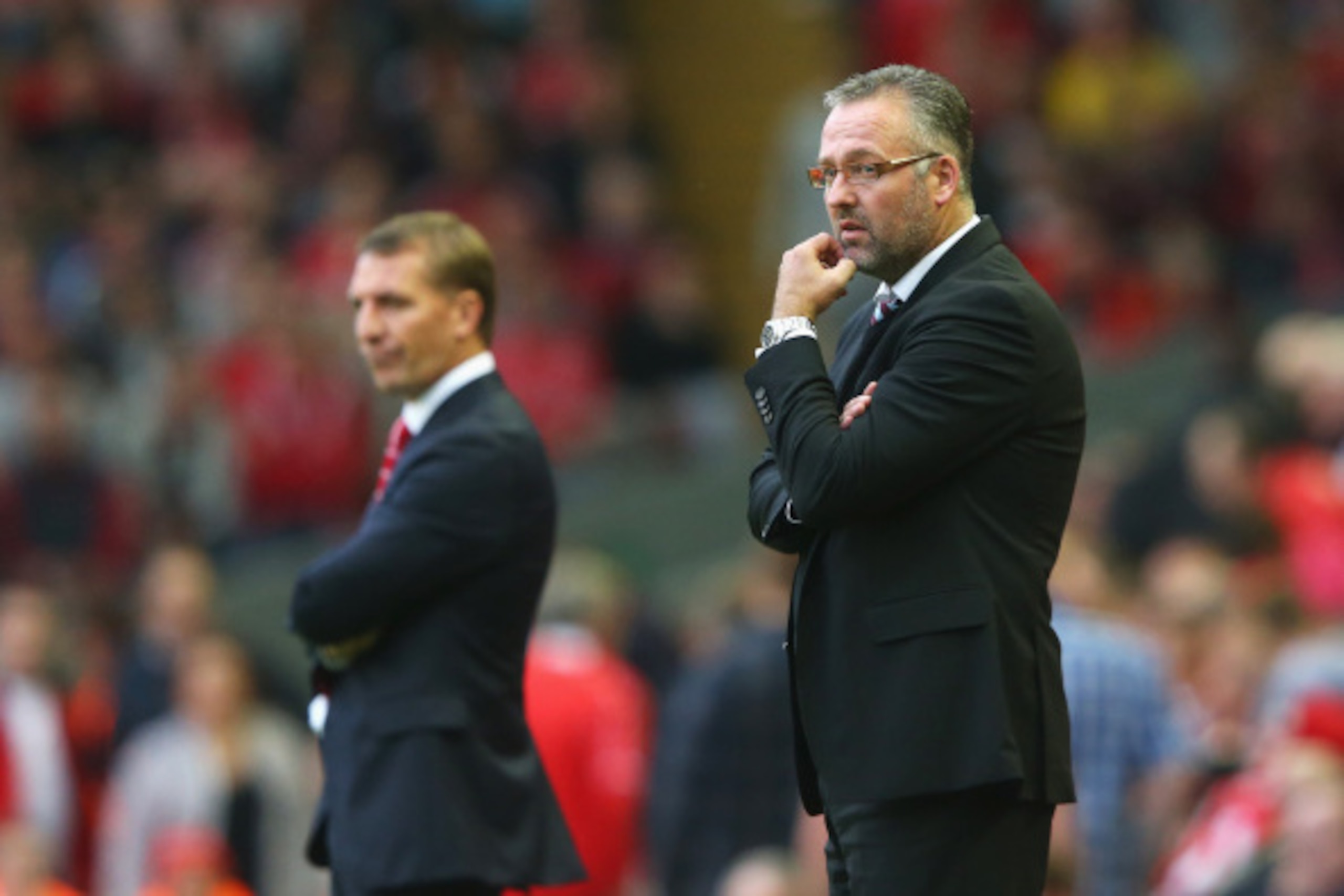 LIVERPOOL, ENGLAND - SEPTEMBER 13: Paul Lambert, manager of Aston Villa looks on with Brendan Rodgers, manager of Liverpool during the Barclays Premier League match between Liverpool and Aston Villa at Anfield on September 13, 2014 in Liverpool, England. 
