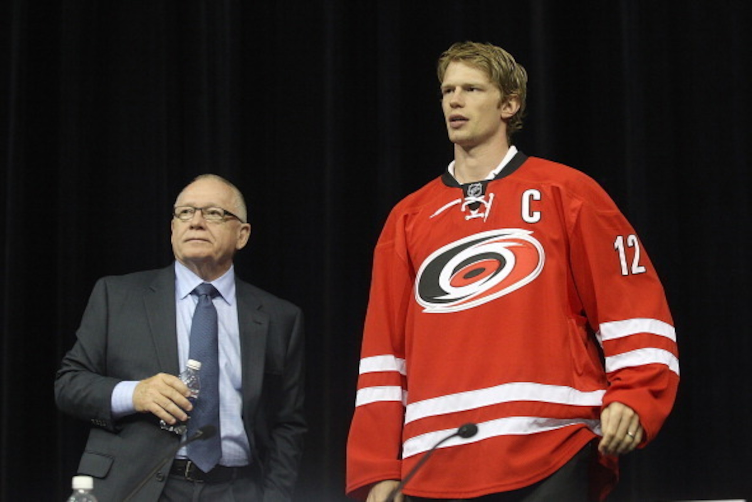 RALEIGH, NC - JUNE 04:  GM Jim Rutherford (L) and Team Captain Eric Staal answer questions from the media during the unveiling of the Carolina Hurricanes' new uniform design for the 2013-2014 season to media and invited guests at PNC Arena on June 4, 2013