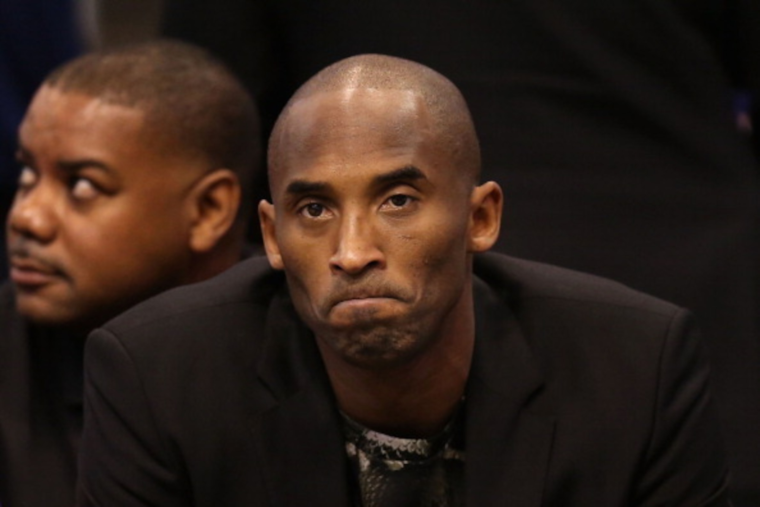 PHOENIX, AZ - JANUARY 15:  Kobe Bryant #24 of the Los Angeles Lakers watches from the bench during the NBA game against the Phoenix Suns at US Airways Center on January 15, 2014 in Phoenix, Arizona.  NOTE TO USER: User expressly acknowledges and agrees th