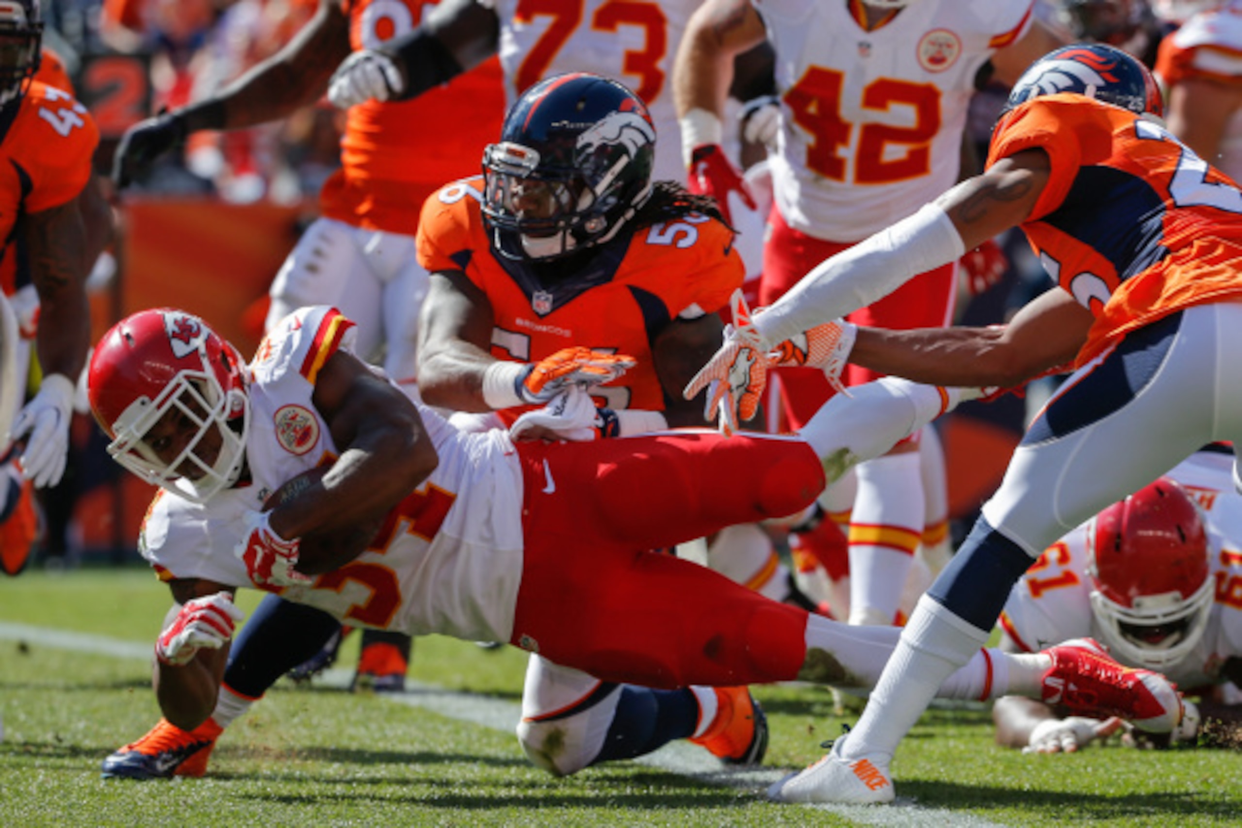 DENVER, CO - SEPTEMBER 14:  Running back Knile Davis #34 of the Kansas City Chiefs scores a touchdown on a 2 yard run in the second quarter of a game against the Denver Broncos at Sports Authority Field at Mile High on September 14, 2014 in Denver, Colora