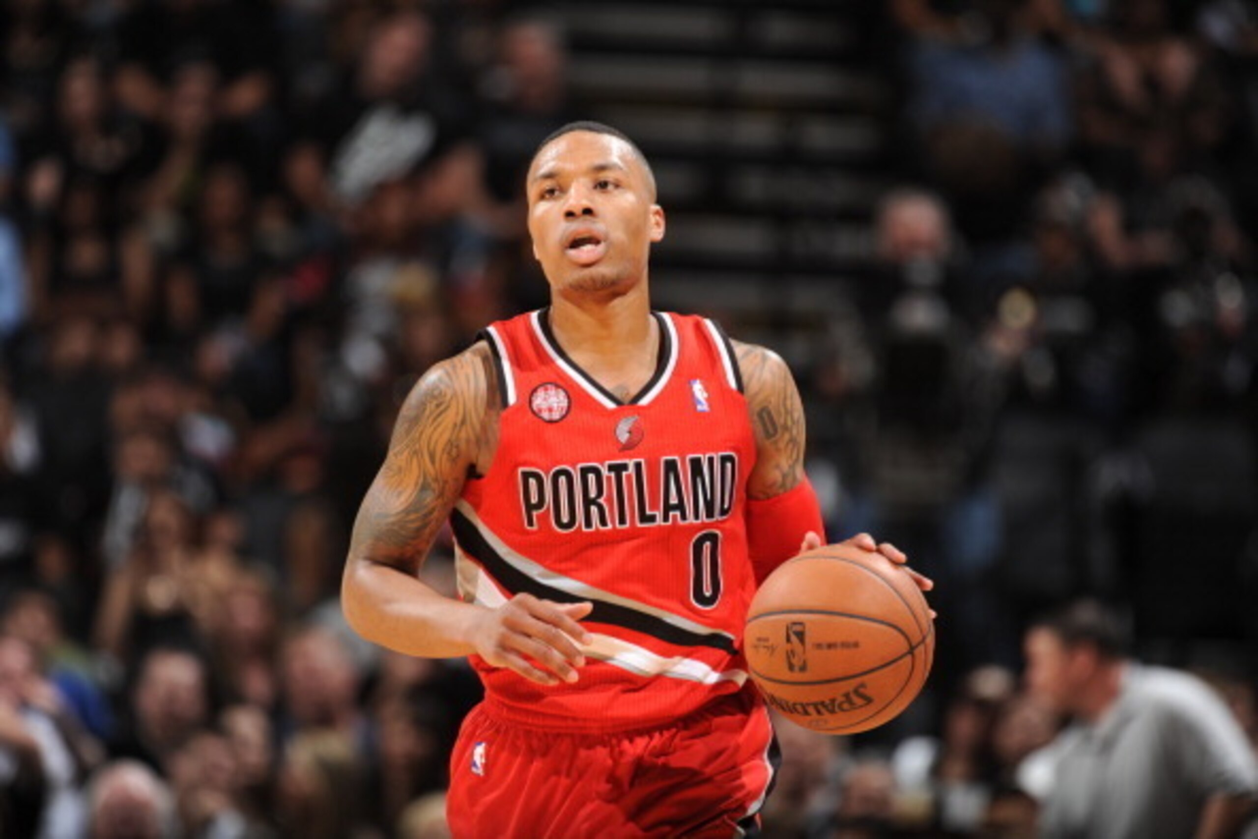 SAN ANTONIO, TX - MAY 14: Damian Lillard #0 of the Portland Trail Blazers moves the ball up-court against the San Antonio Spurs in Game Five of the Western Conference Semifinals during the 2014 NBA Playoffs on May 14, 2014 at the AT&T Center in San Antoni
