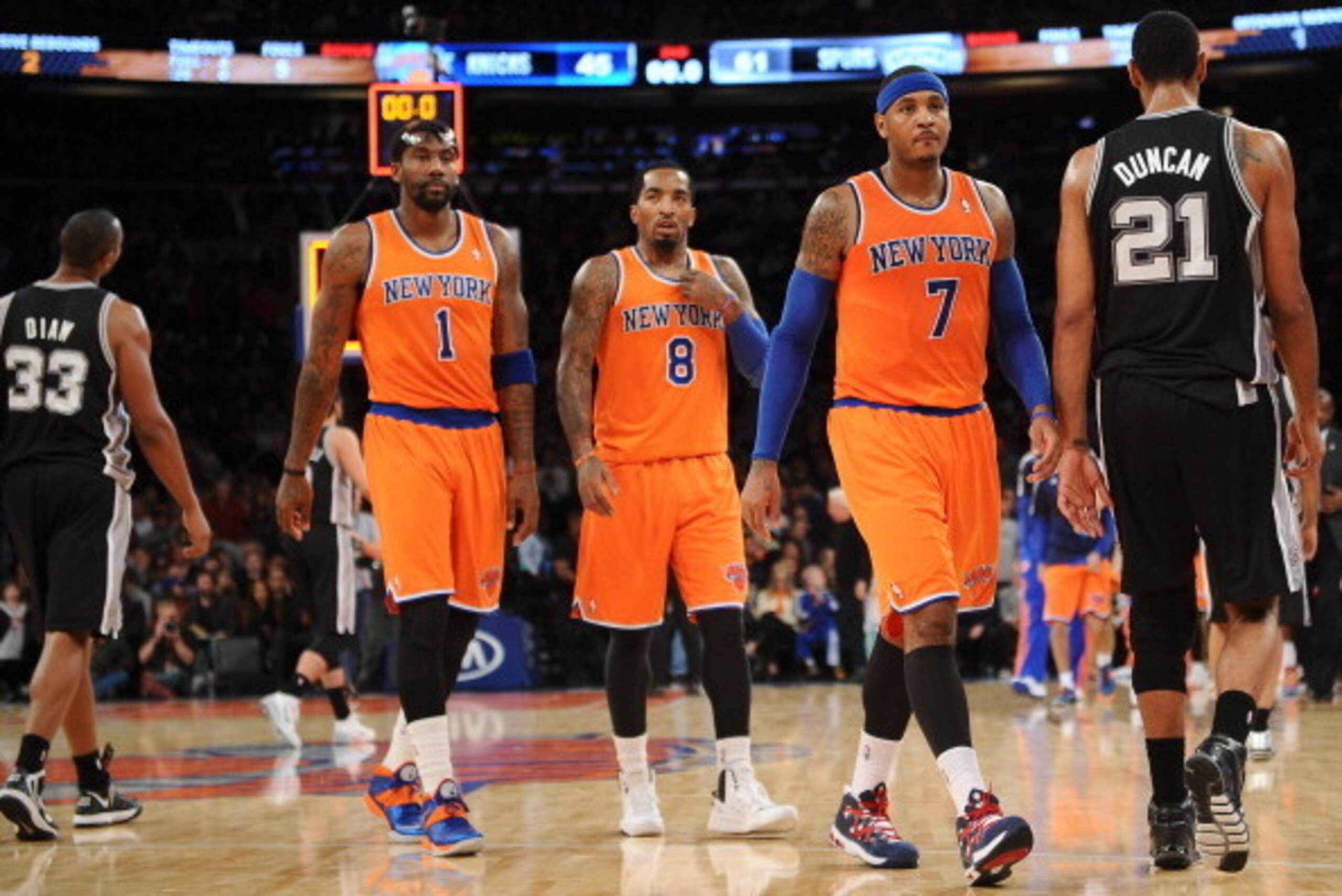 NEW YORK, NY - NOVEMBER 10:  Carmelo Anthony #7 of the New York Knicks and his teammates J.R. Smith #8 and Amar'e Stoudemire #1 walk into the locker room at half time against the San Antonio Spurs at Madison Square Garden on November 10, 2013 in New York 