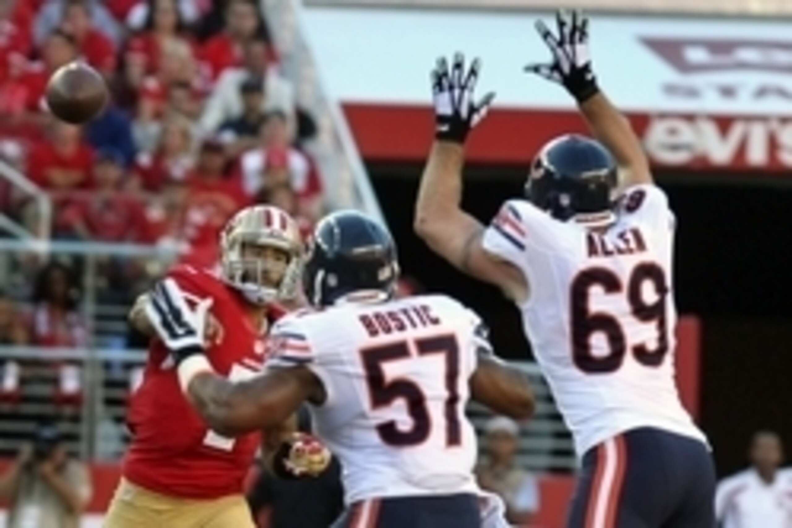 Sep 14, 2014; Santa Clara, CA, USA; San Francisco 49ers quarterback Colin Kaepernick (7) throws under pressure from Chicago Bears Jonathan Bostic (57) and Jared Allen (69) in the first quarter at Levis Stadium. Mandatory Credit: Lance Iversen-USA TODAY Sp