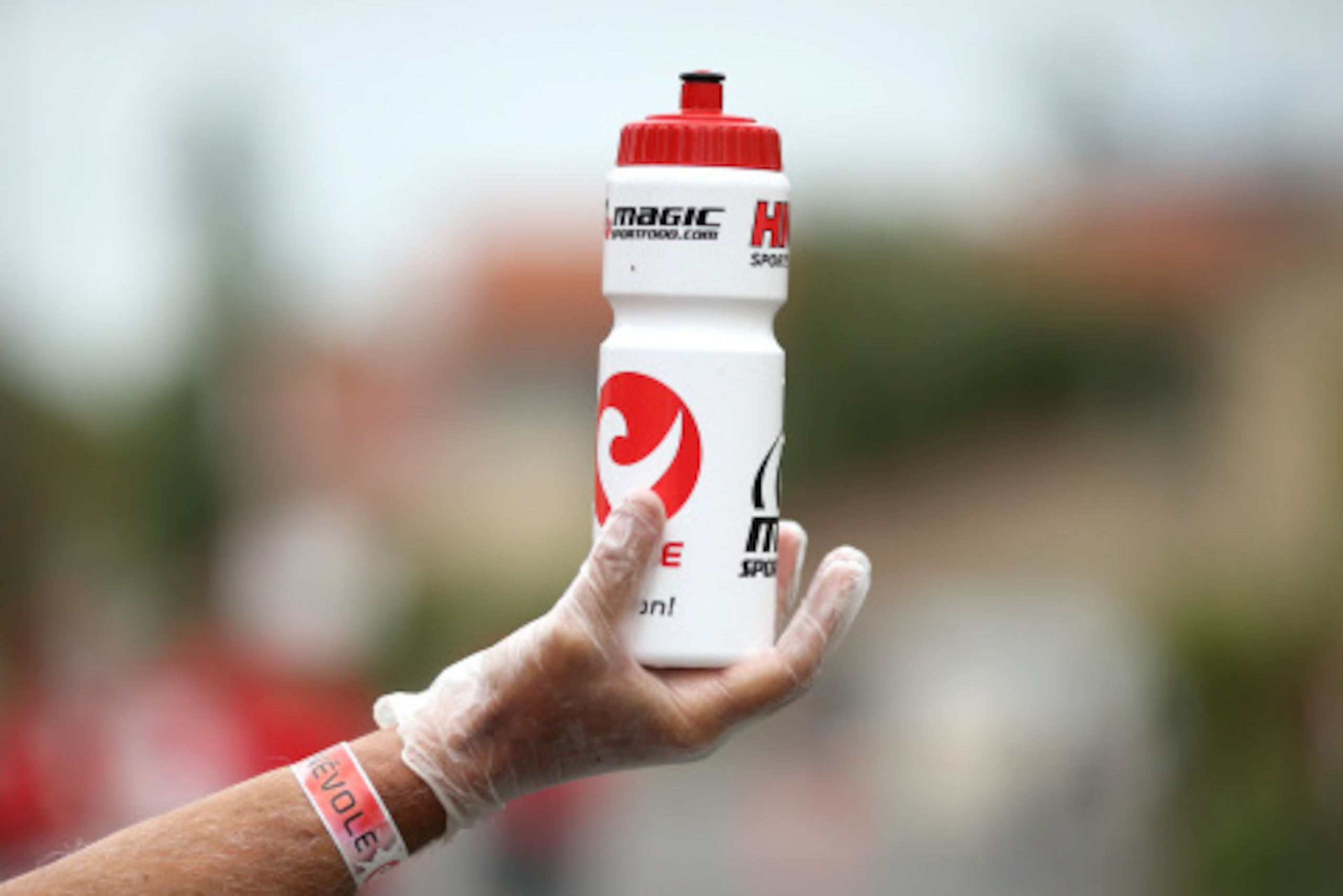 VICHY, FRANCE - AUGUST 31:  A drink bottle is offered at a water station during the Challenge Triathlon Vichy on August 31, 2014 in Vichy, France. (Photo by Stephen Pond/Getty Images for Challenge Triathlon)