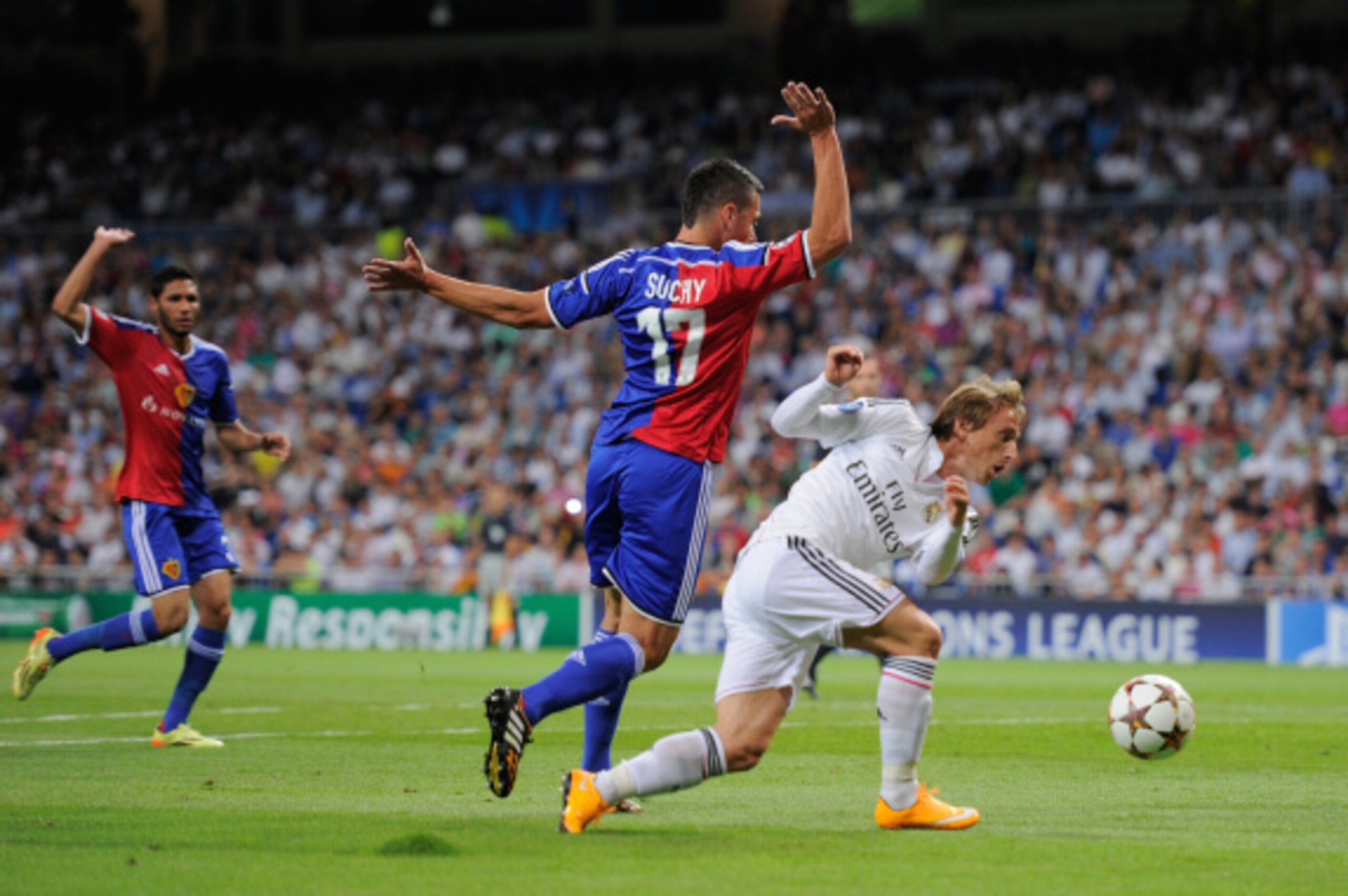 MADRID, SPAIN - SEPTEMBER 16:  Luka Modric of Real Madrid in action against Marek Suchy of FC Basel 1893 during the UEFA Champions League Group B match between Real Madrid CF and FC Basel 1893 on September 16, 2014 in Madrid, Spain.  (Photo by Denis Doyle