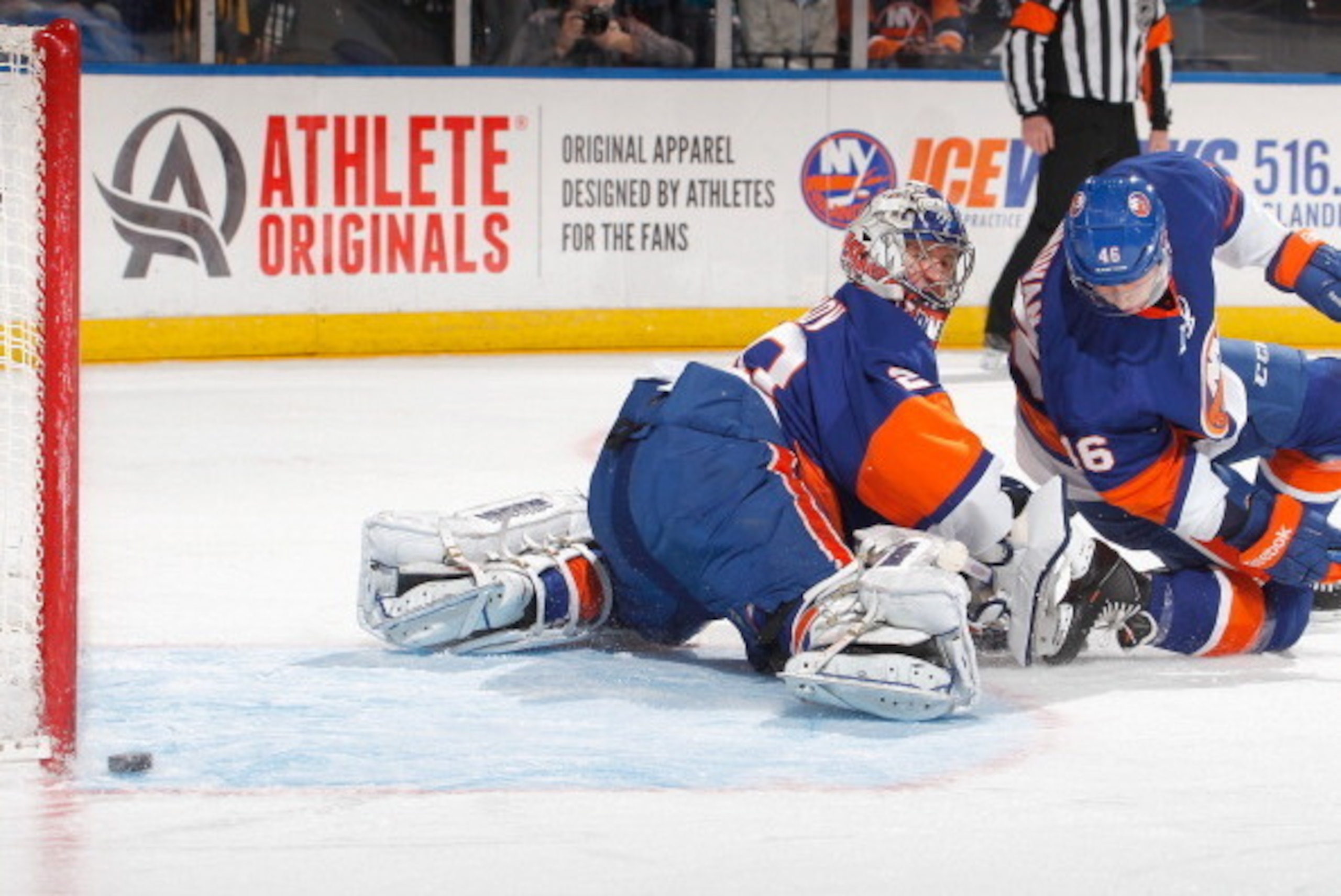 UNIONDALE, NY - MARCH 14: Goalie Evgeni Nabokov #20 of the Islanders looks back as a shot by the San Jose Sharks hits the goalpost by the empty side of the net during the first period of an NHL hockey game at Nassau Veterans Memorial Coliseum on March 14 UNIONDALE, NY - MARCH 14: Goalie Evgeni Nabokov #20 of the Islanders looks back as a shot by the San Jose Sharks hits the goalpost by the empty side of the net during the first period of an NHL hockey game at Nassau Veterans Memorial Coliseum on March 14