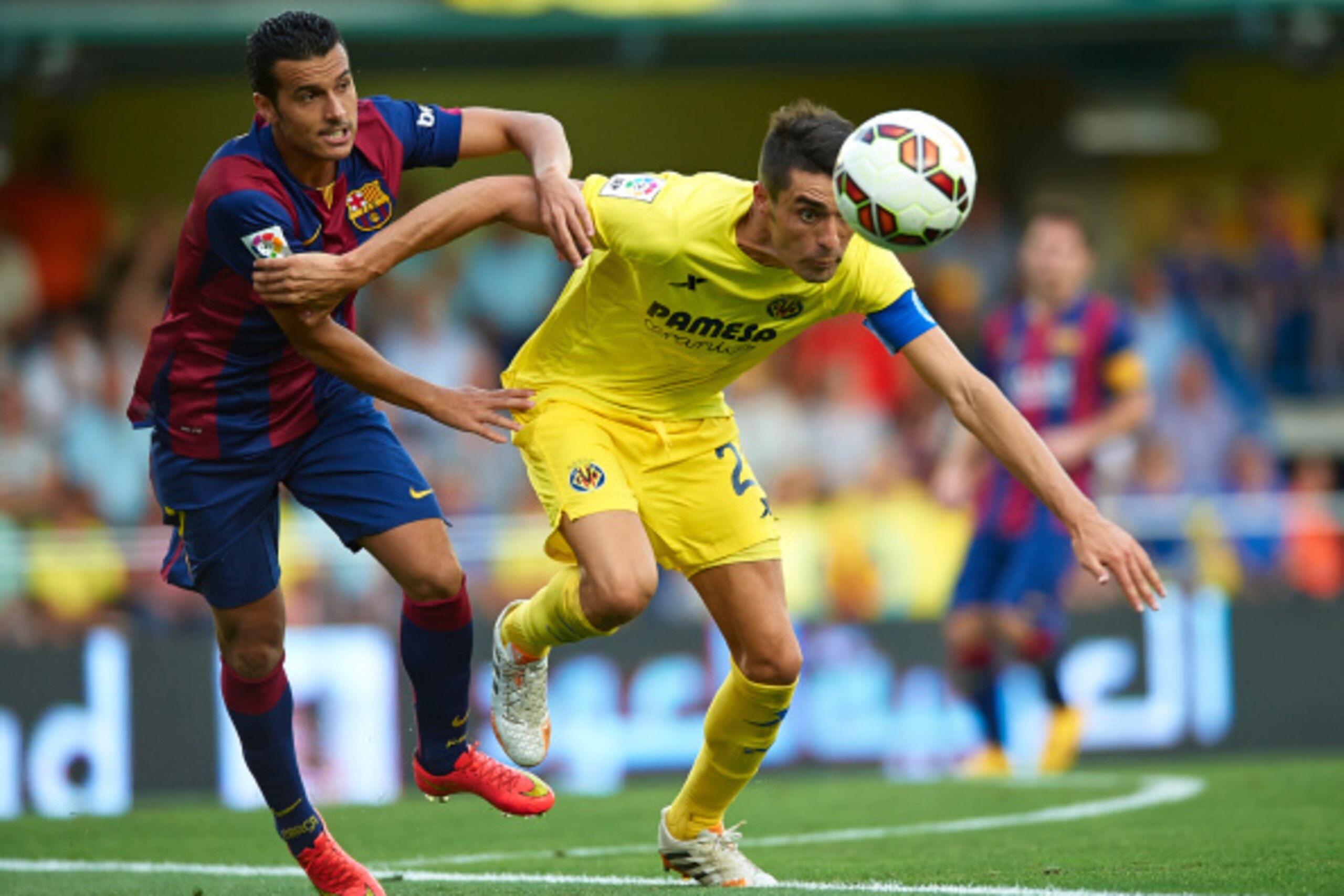 VILLARREAL, SPAIN - AUGUST 31:  Pedro of Barcelona competes for the ball with Bruno Soriano (R) of Villarreal during the La Liga match between Villarreal CF and FC Barcelona at El Madrigal stadium on August 31, 2014 in Villarreal, Spain.  (Photo by Manuel