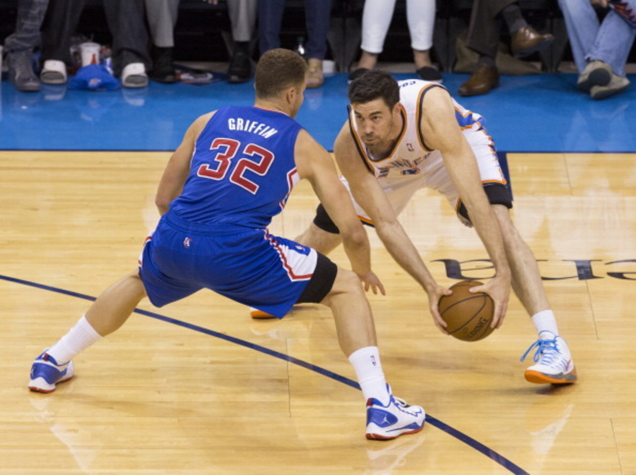 OKLAHOMA CITY, OK - May 13: Nick Collison #4 of the Oklahoma City Thunder looks to make a play with the ball against Blake Griffin #32 of the Los Angeles Clippers in Game 5 of the Western Conference Semifinals during the 2014 NBA Playoffs at the Chesapeak