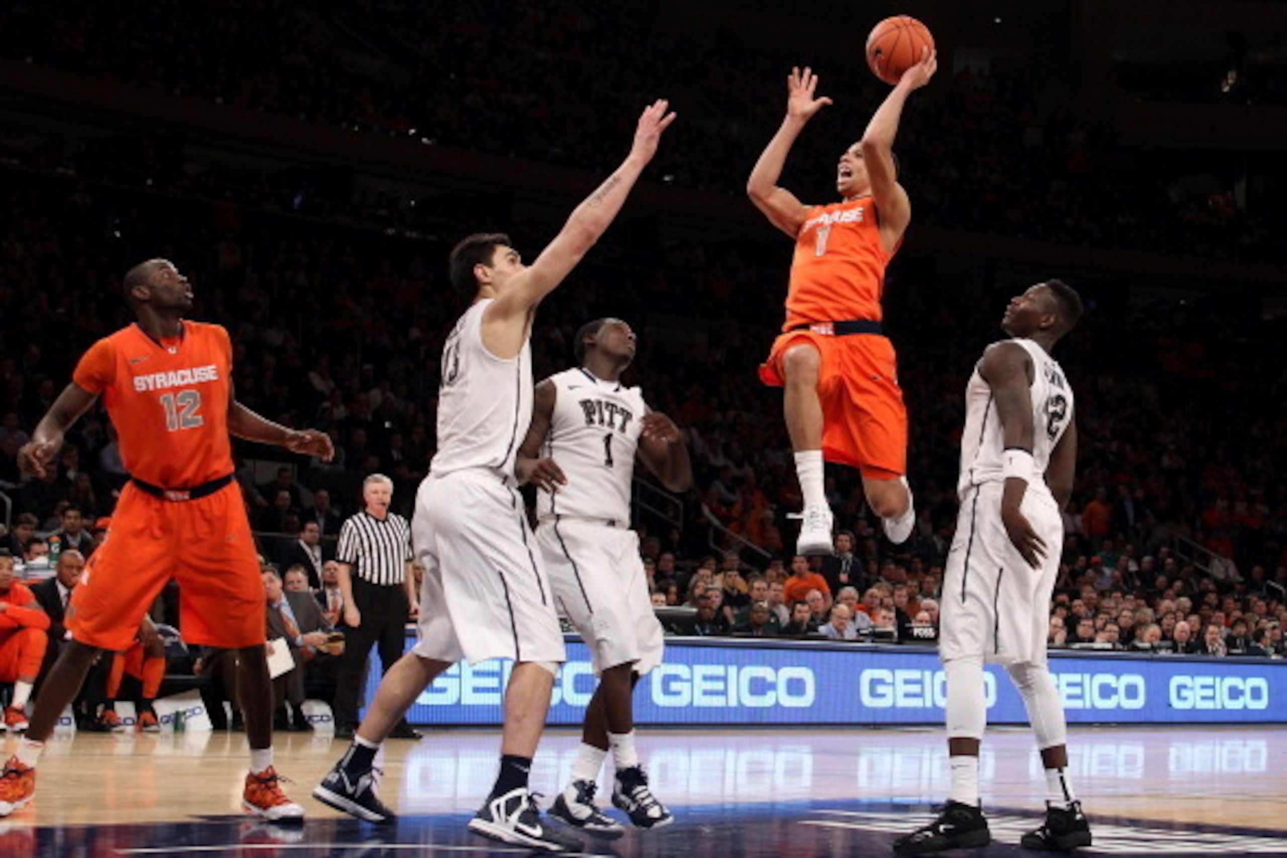 NEW YORK, NY - MARCH 14:  Michael Carter-Williams #1 of the Syracuse Orange drives for a shot attempt in the second half against Steven Adams #13, Tray Woodall #1 and Talib Zanna #42 of the Pittsburgh Panthers during the quaterfinals of the Big East Men's