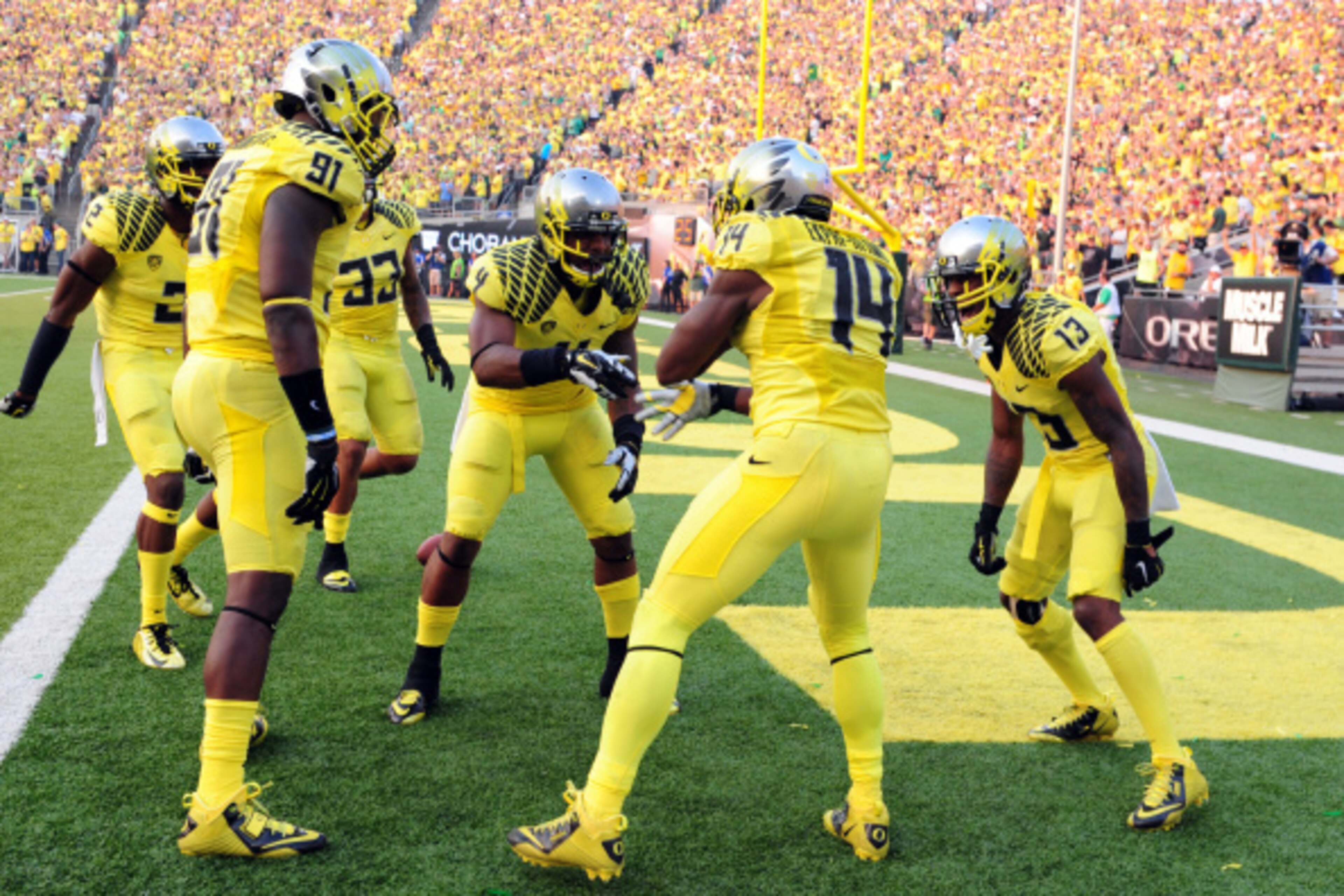 EUGENE, OR -SEPTEMBER 06: Defensive back Ifo Ekpre-Olomu #14 of the Oregon Ducks celebrates  with his teammates after intercepting a pass during the fourth quarter of the game against the Michigan State Spartans at Autzen Stadium on September 6, 2014 in E