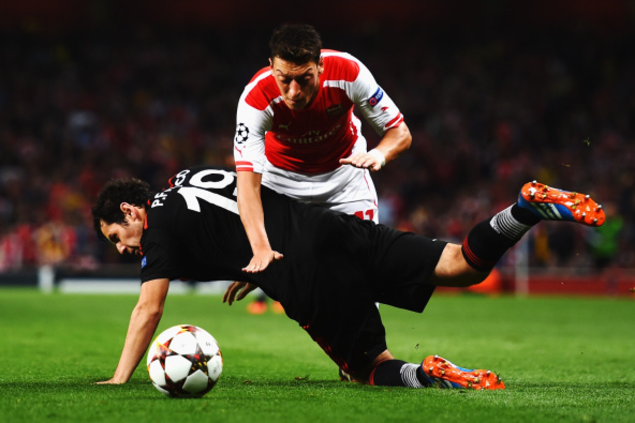 LONDON, ENGLAND - AUGUST 27:  Mesut Oezil of Arsenal is challenged by Pedro Franco of Besiktas during the UEFA Champions League Qualifier 2nd leg match between Arsenal and Besiktas at the Emirates Stadium on August 27, 2014 in London, United Kingdom.  (Ph