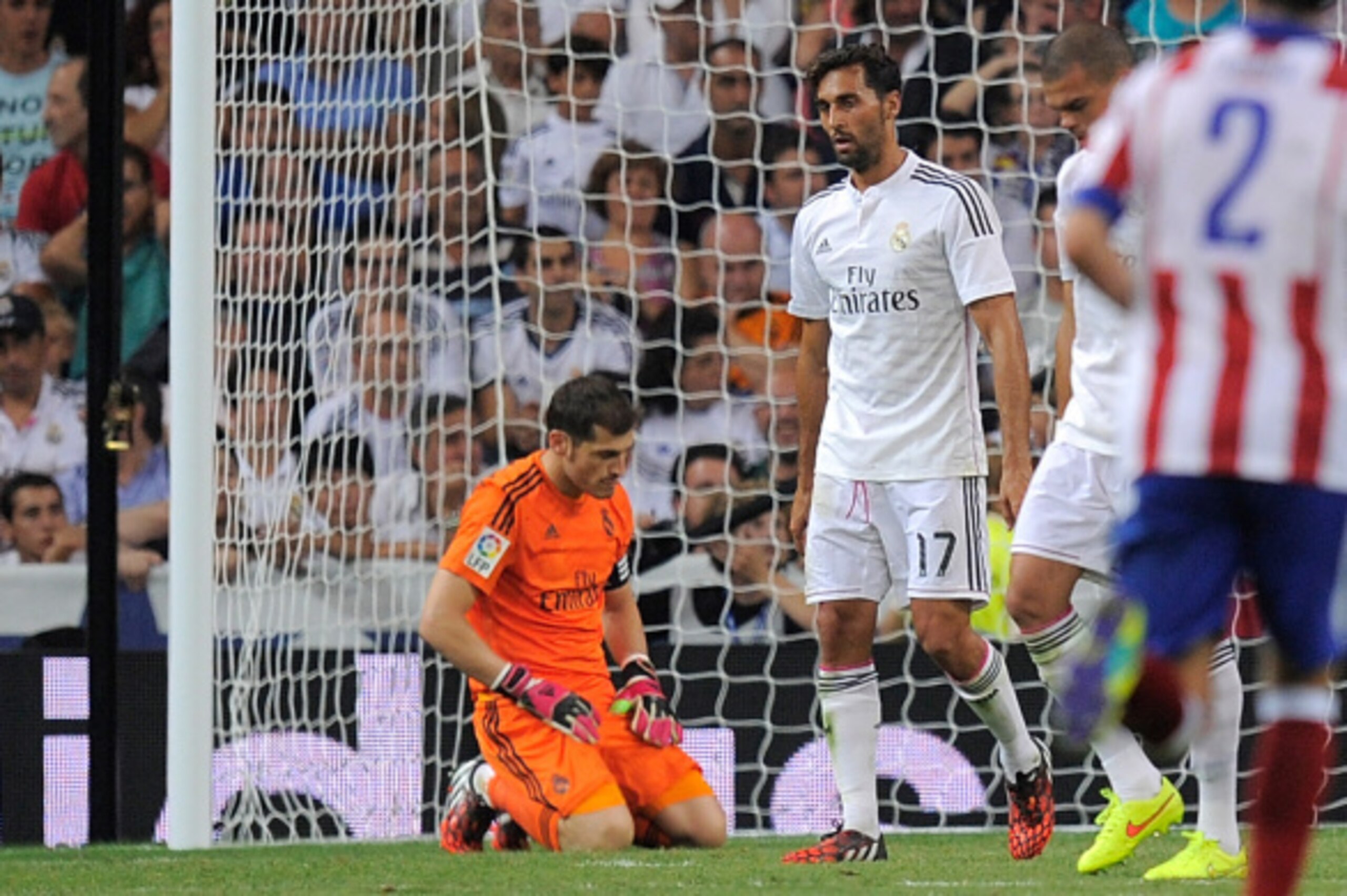 MADRID, SPAIN - SEPTEMBER 13:  Iker Casillas of Real Madrid reacts after failing to stop Atletico de Madrid scoring their 2nd goal during the La Liga match between Real Madrid and Atletico de Madrid at Estadio Santiago Bernabeu on September 13, 2014 in Ma