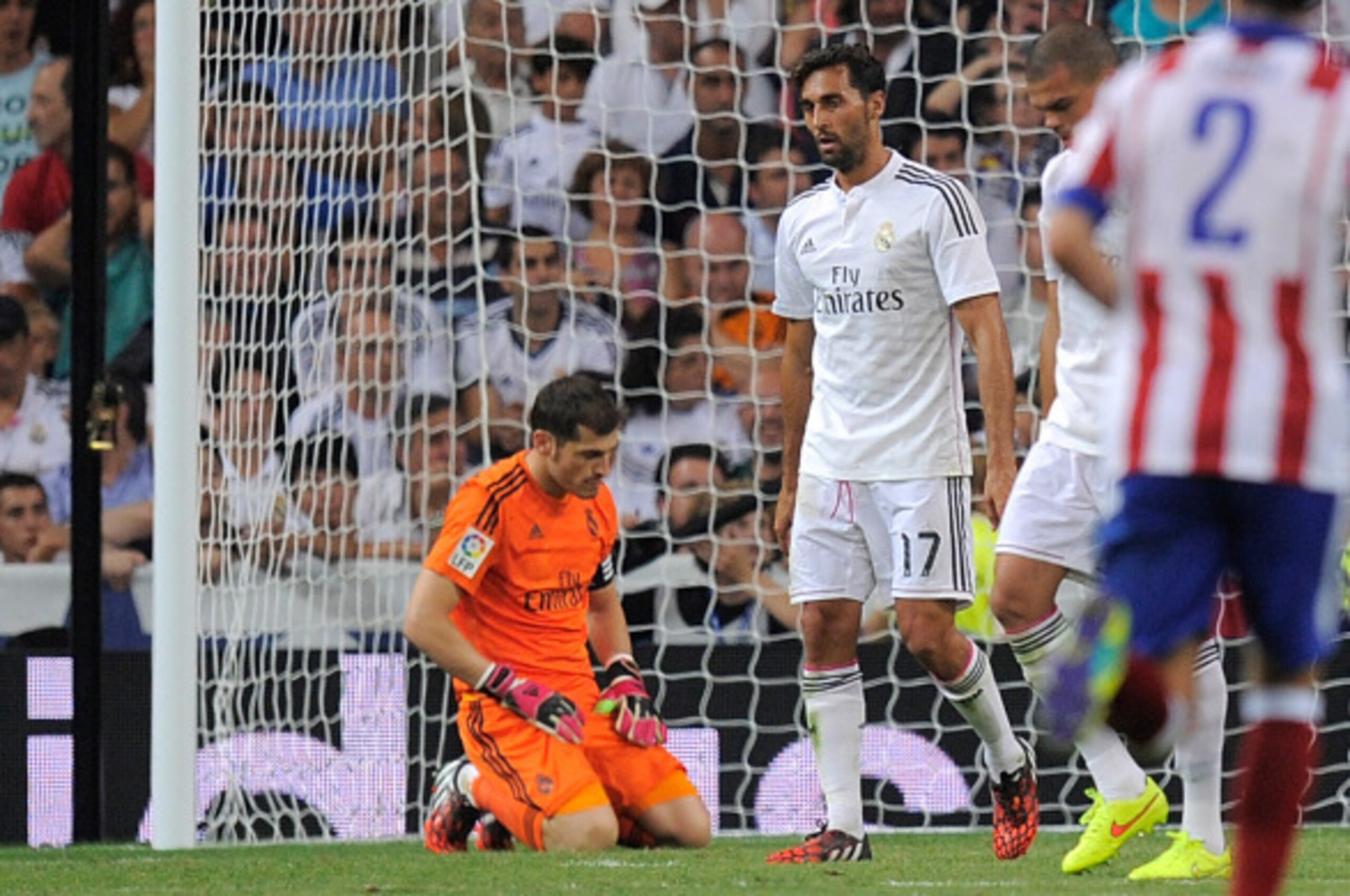 MADRID, SPAIN - SEPTEMBER 13:  Iker Casillas of Real Madrid reacts after failing to stop Atletico de Madrid scoring their 2nd goal during the La Liga match between Real Madrid and Atletico de Madrid at Estadio Santiago Bernabeu on September 13, 2014 in Ma