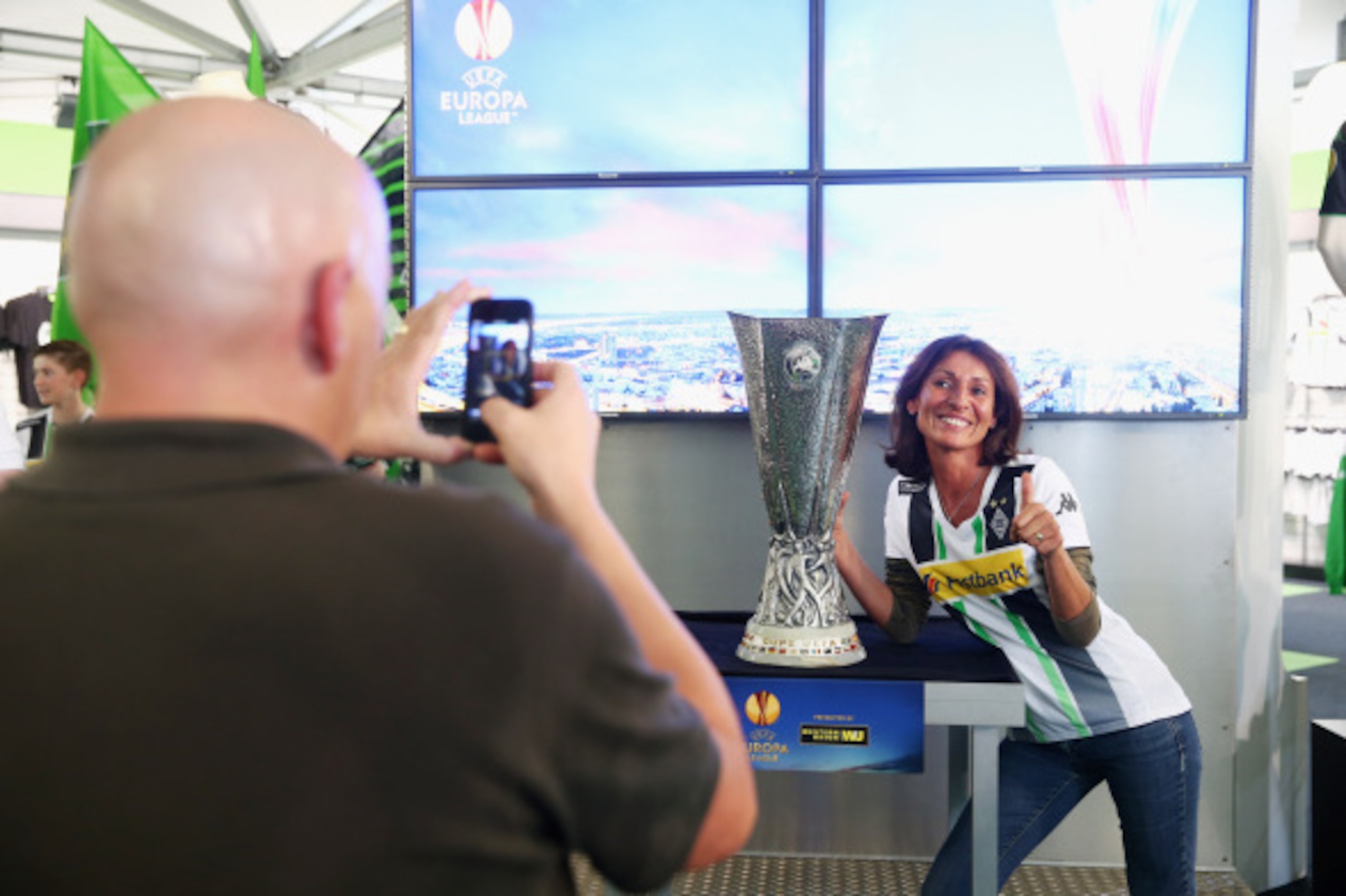 MOENCHENGLADBACH, GERMANY - SEPTEMBER 16:  Fans take pictures with the Trophy during the UEFA Europa League Trophy Tour at Borussia-Park on September 16, 2014 in Moenchengladbach, Germany.  (Photo by Mathis Wienand/Getty Images)