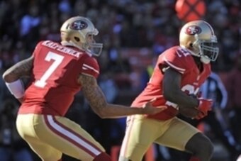 December 30, 2012; San Francisco, CA, USA; San Francisco 49ers quarterback Colin Kaepernick (7) hands the ball off to running back Frank Gore (21) during the first quarter against the Arizona Cardinals at Candlestick Park. Mandatory Credit: Kyle Terada-US
