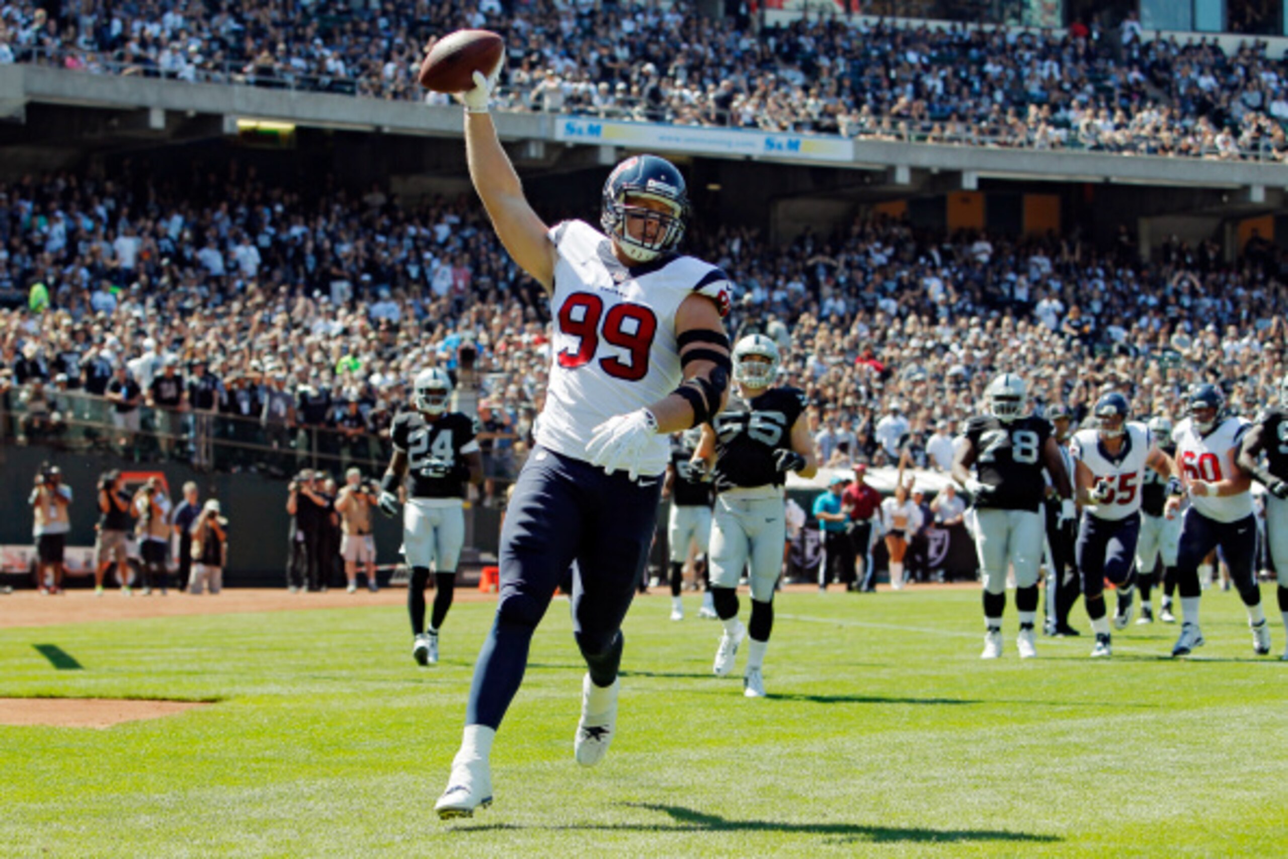 OAKLAND, CA - SEPTEMBER 14:  J.J. Watt #99 of the Houston Texans celebrates after scoring a touchdown against the Oakland Raiders in the first quarter on September 14, 2014 at O.co Coliseum in Oakland, California.  The Texans lead 17-0 in the second quart