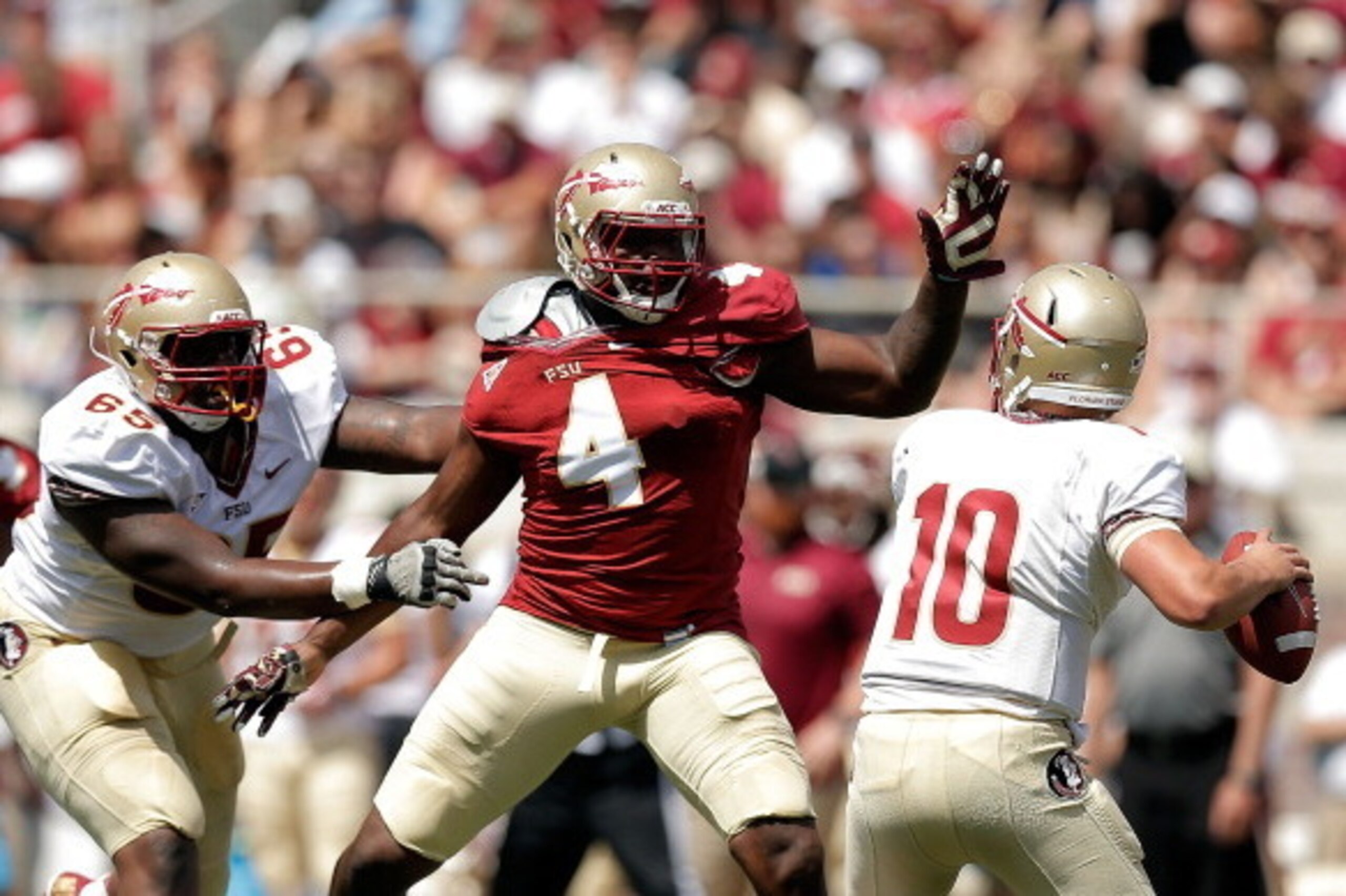 TALLAHASSEE, FL - APRIL 12:  Giorgio Newberry #4 of the Garnet team pressures Sean Maguire #10 of the Gold team during Florida State's Garnet and Gold spring game at Doak Campbell Stadium on April 12, 2014 in Tallahassee, Florida.  (Photo by Stacy Revere/