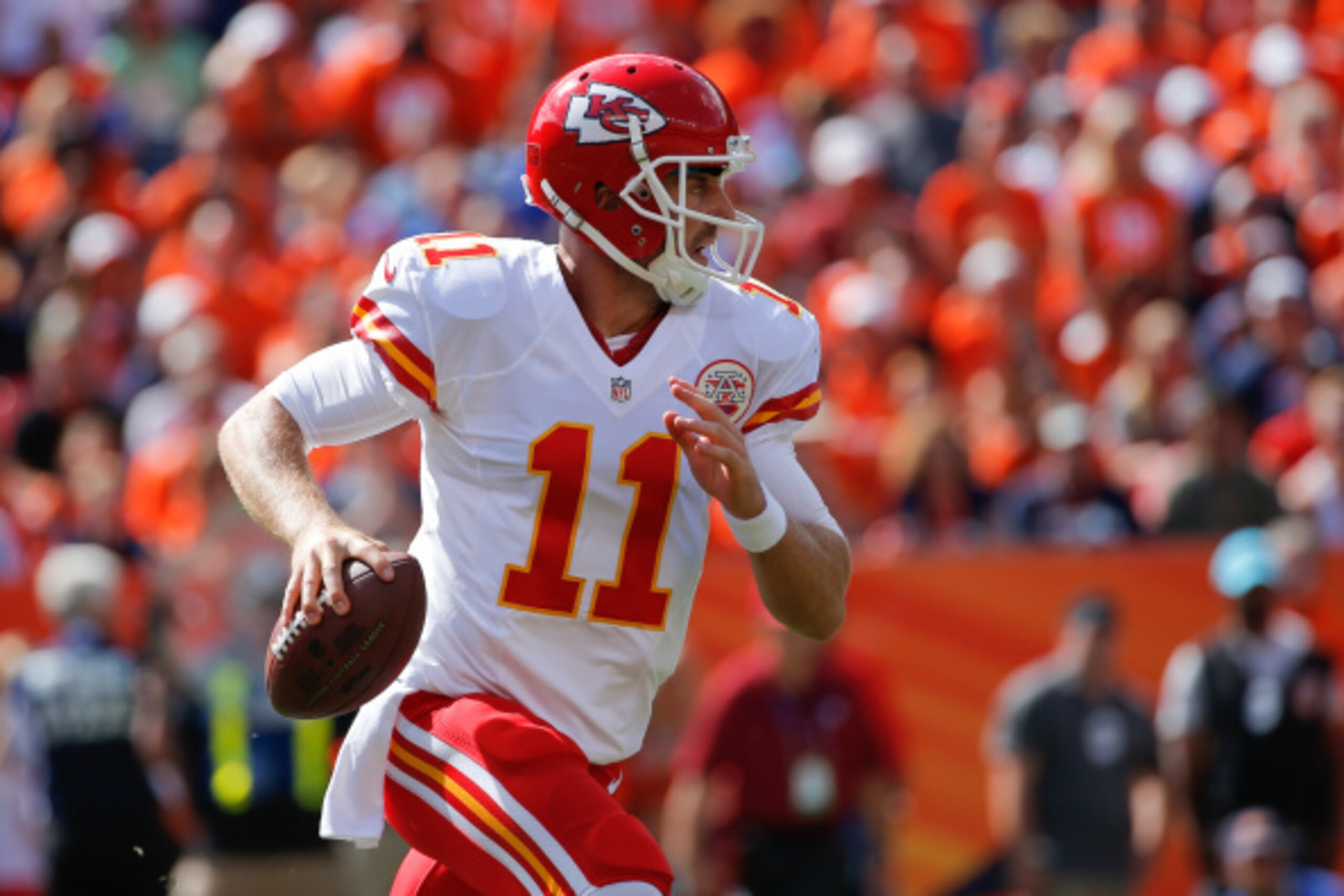 DENVER, CO - SEPTEMBER 14:  Quarterback Alex Smith #11 of the Kansas City Chiefs scrambles against the Denver Broncos int he first quarter of a game at Sports Authority Field at Mile High on September 14, 2014 in Denver, Colorado.  (Photo by Doug Pensinge