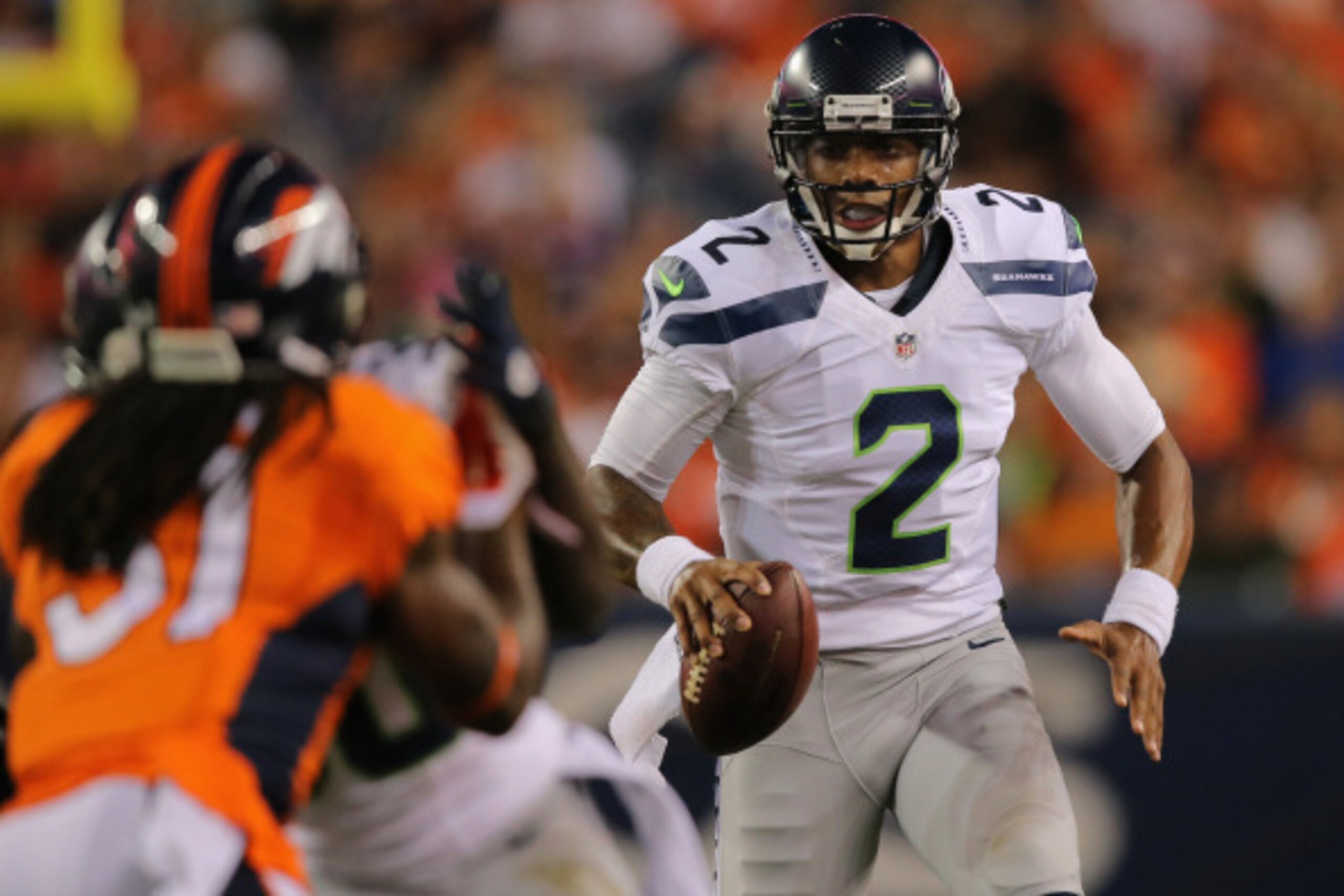 DENVER, CO - AUGUST 07:  Quarterback Terrelle Pryor #2 of the Seattle Seahawks scrambles with the ball against the Denver Broncos during preseason action at Sports Authority Field at Mile High on August 7, 2014 in Denver, Colorado. The Broncos defeated th